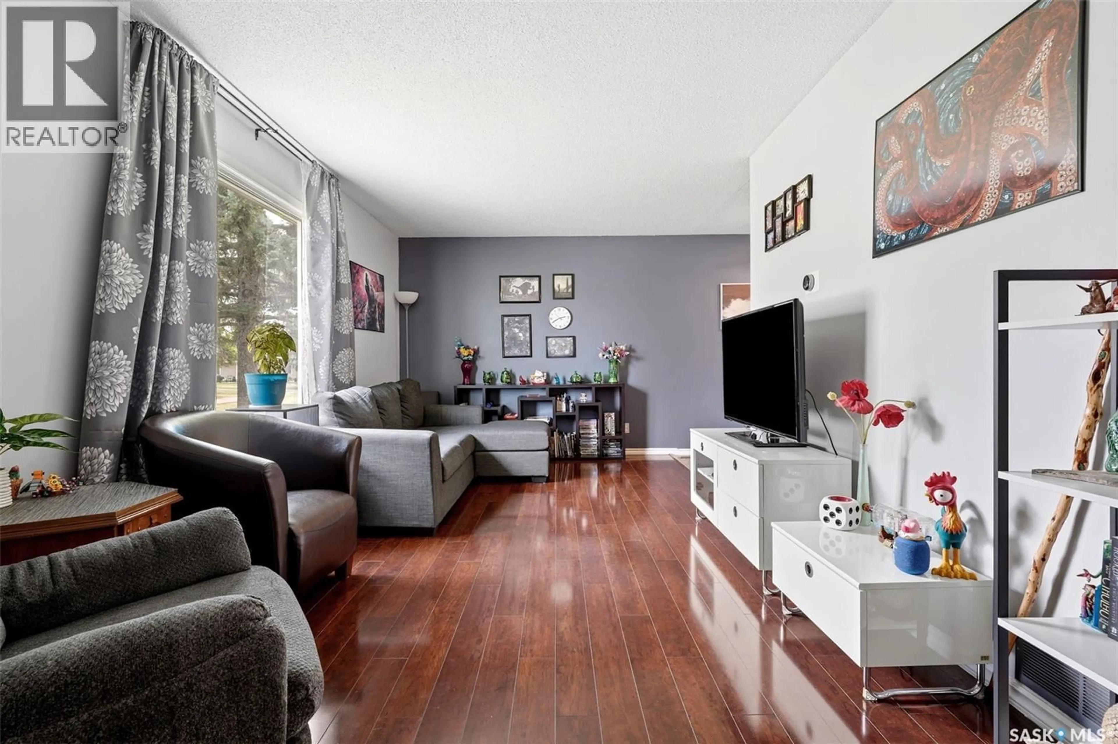 Living room with furniture, wood/laminate floor for 4168 CASTLE ROAD, Regina Saskatchewan S4S4T2