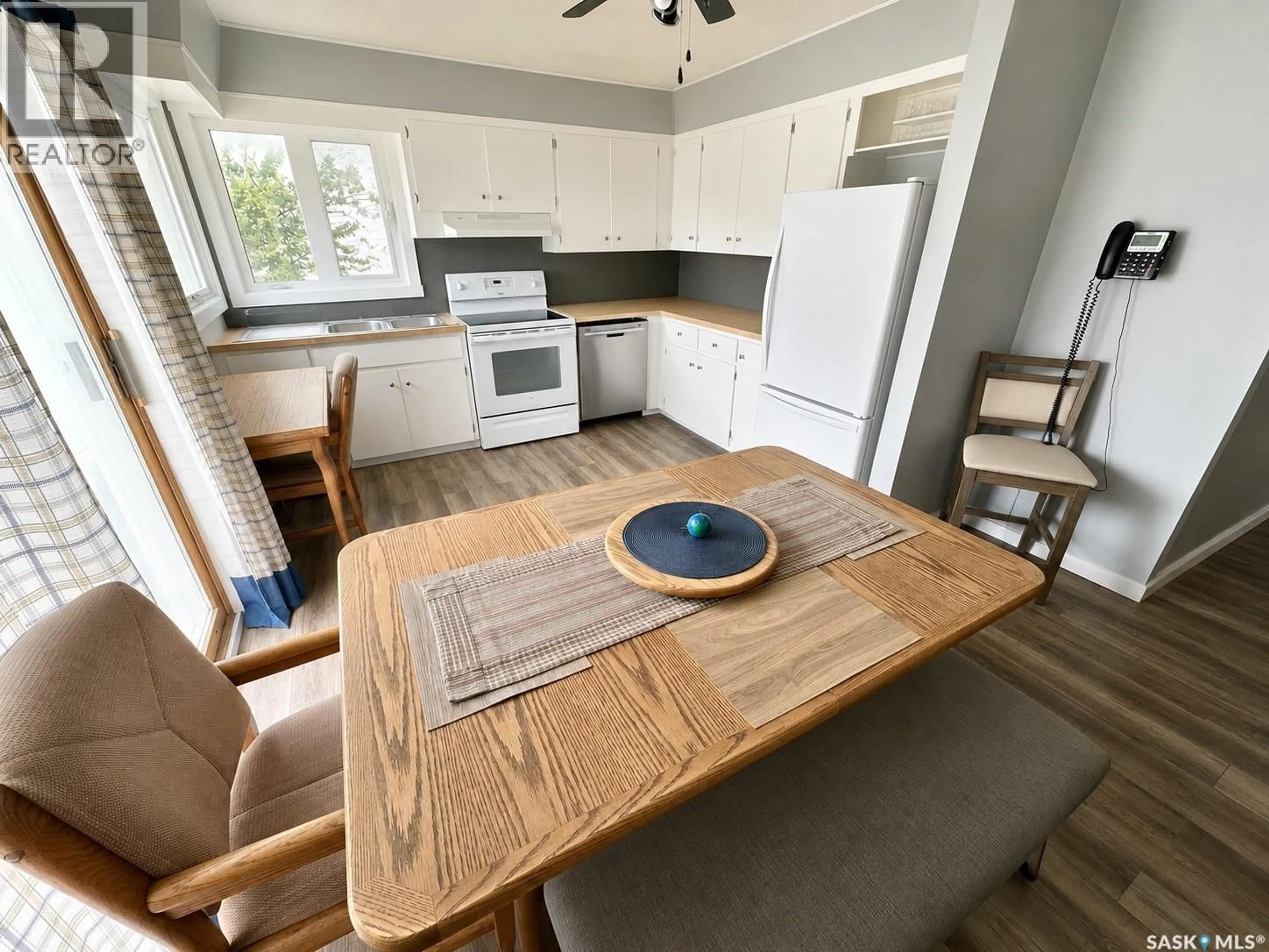 Open concept kitchen, wood/laminate floor for 812 3RD STREET, Weyburn Saskatchewan S4H2E6