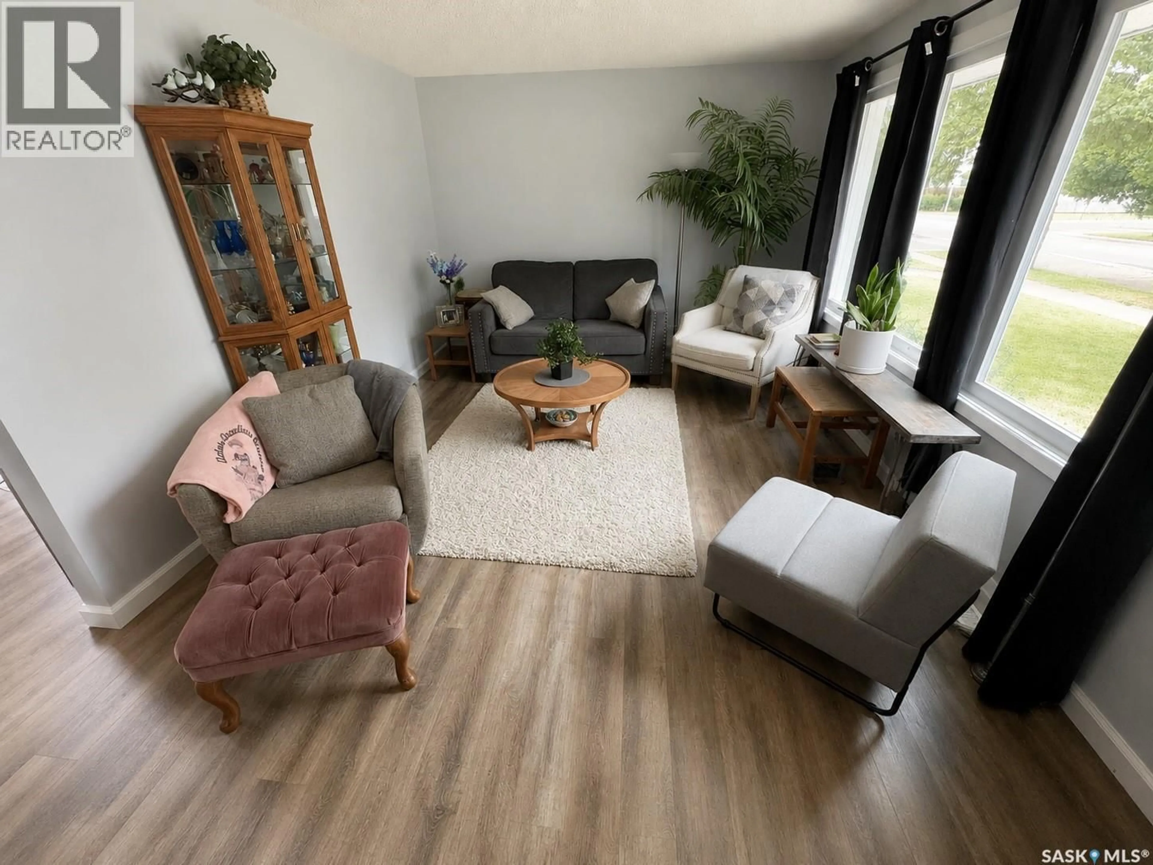 Living room with furniture, wood/laminate floor for 812 3RD STREET, Weyburn Saskatchewan S4H2E6