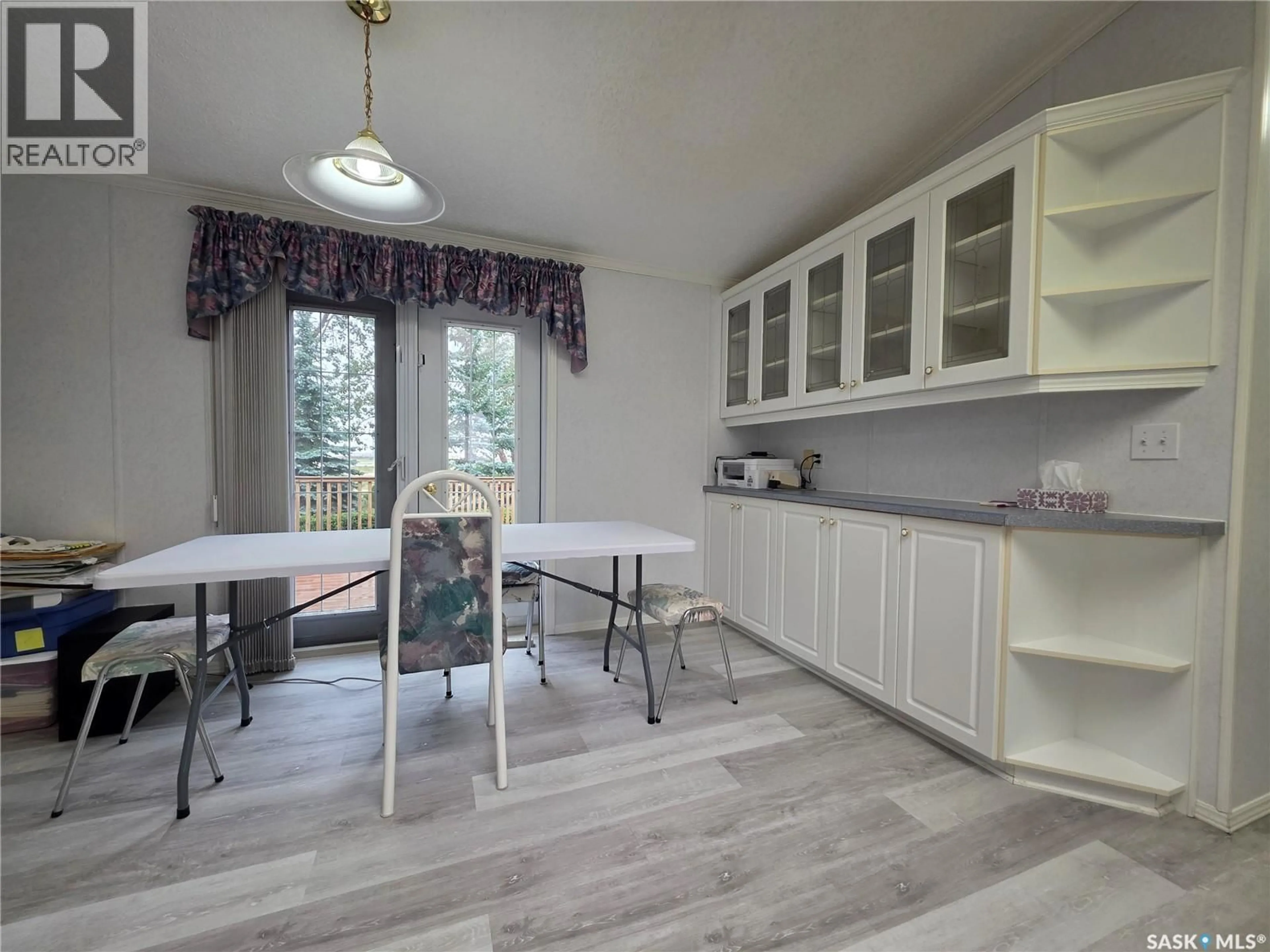 Open concept kitchen, wood/laminate floor for 61 PRAIRIE SUN COURT, Swift Current Saskatchewan S9H3X6