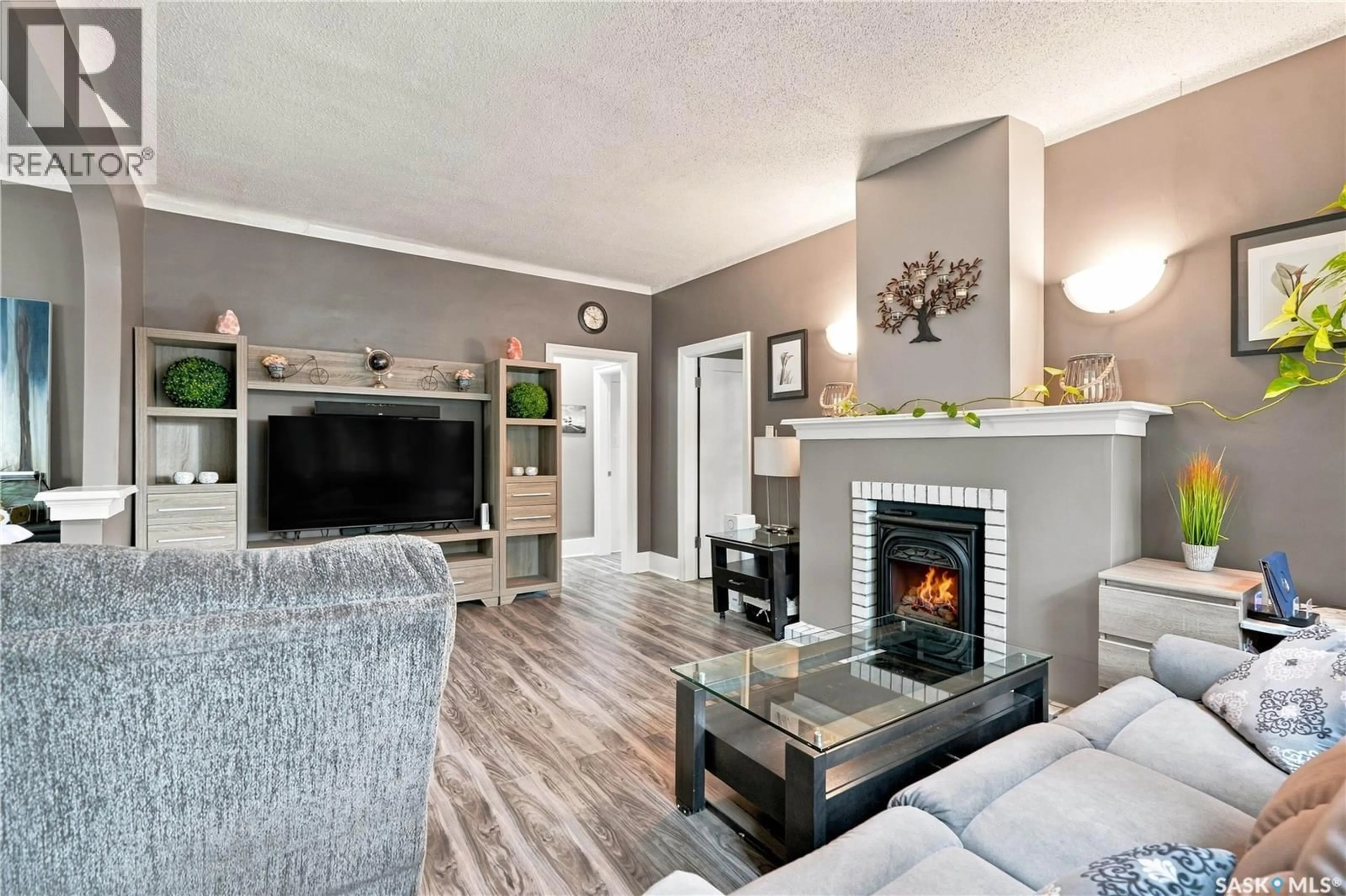 Living room with furniture, wood/laminate floor for 2011 LORNE AVENUE, Saskatoon Saskatchewan S7J0R4