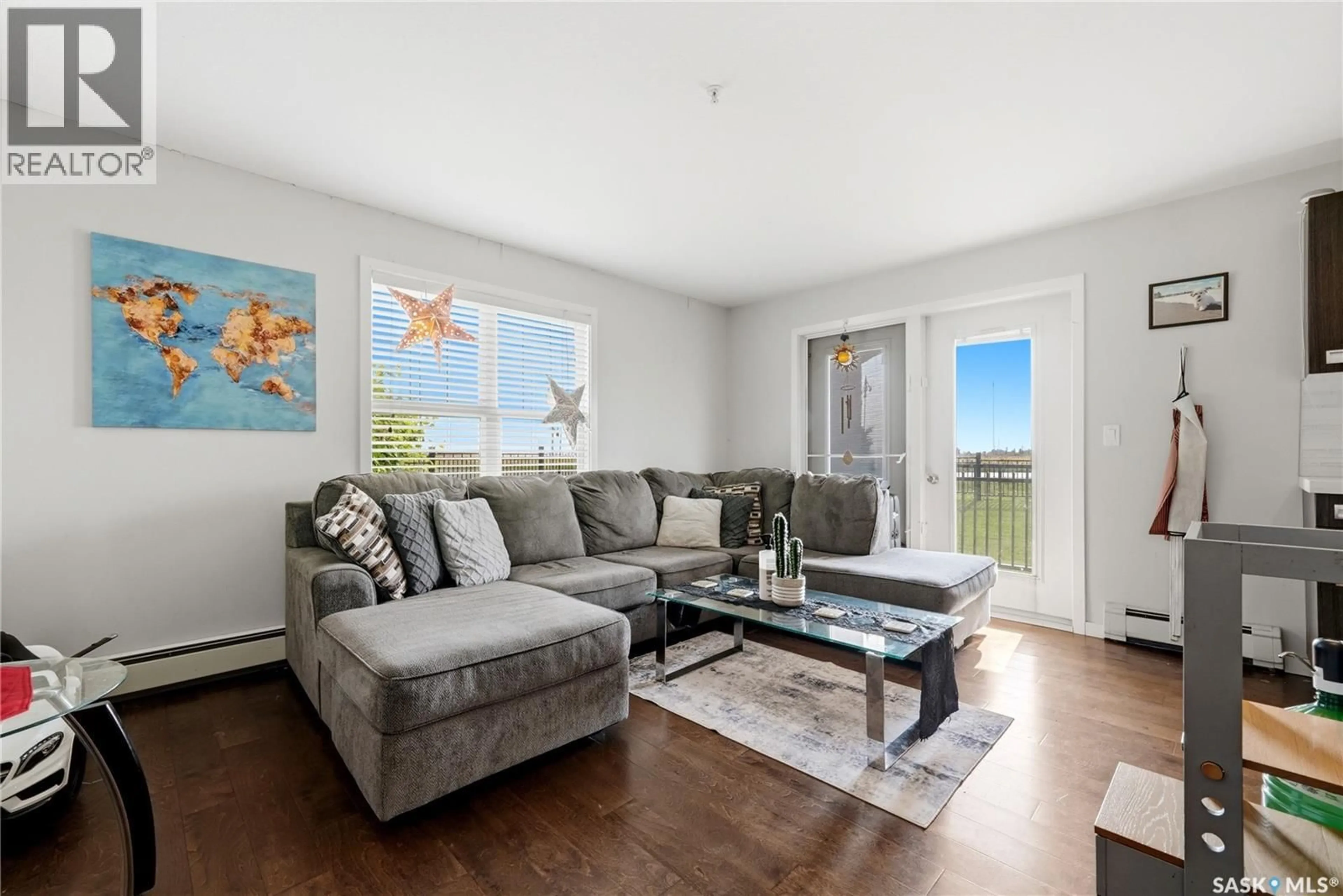 Living room with furniture, wood/laminate floor for 109 - 1545 NEVILLE DRIVE, Regina Saskatchewan S4Z0A7