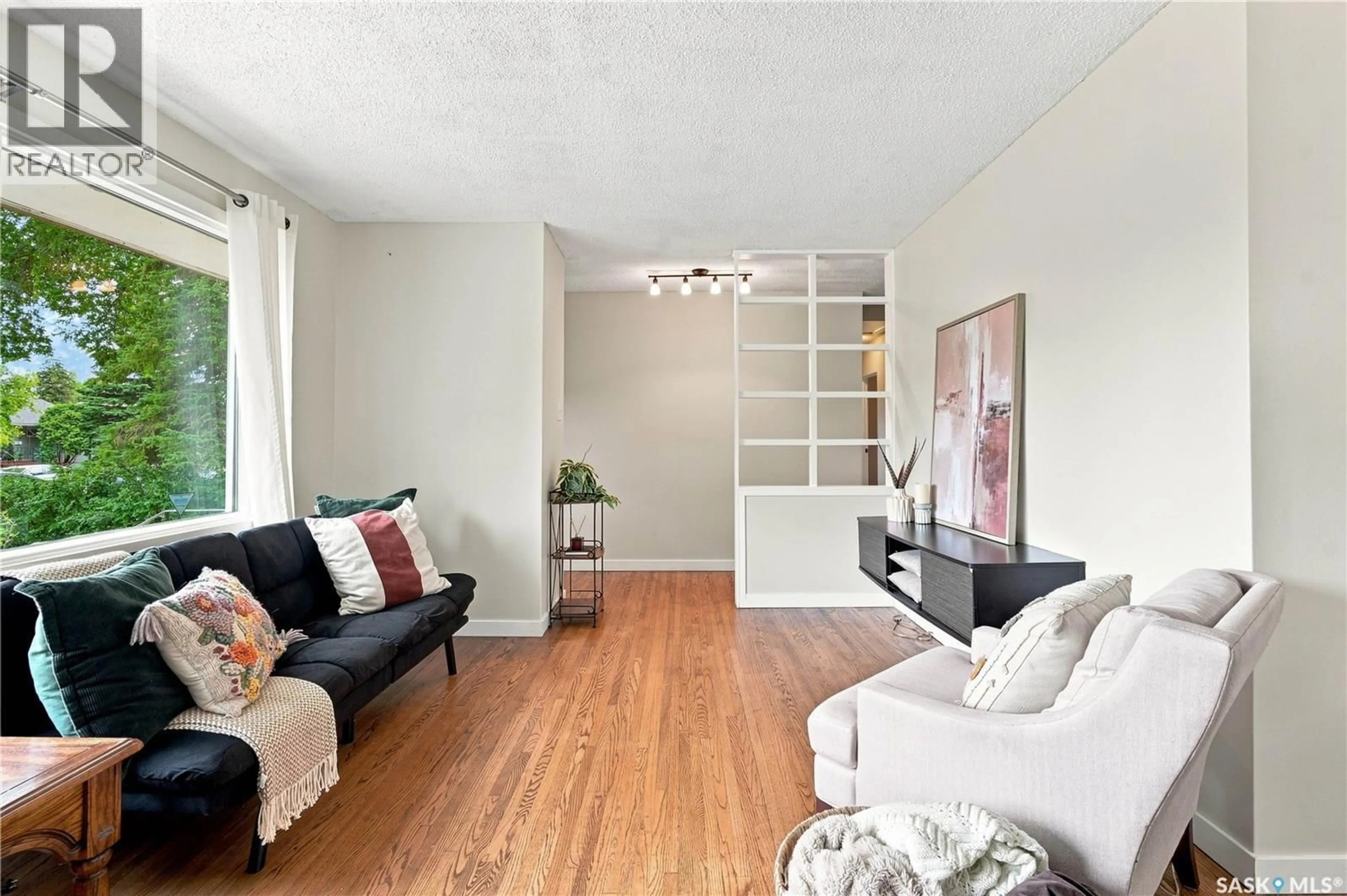 Living room with furniture, wood/laminate floor for 2302 HANOVER AVENUE, Saskatoon Saskatchewan S7J1E6