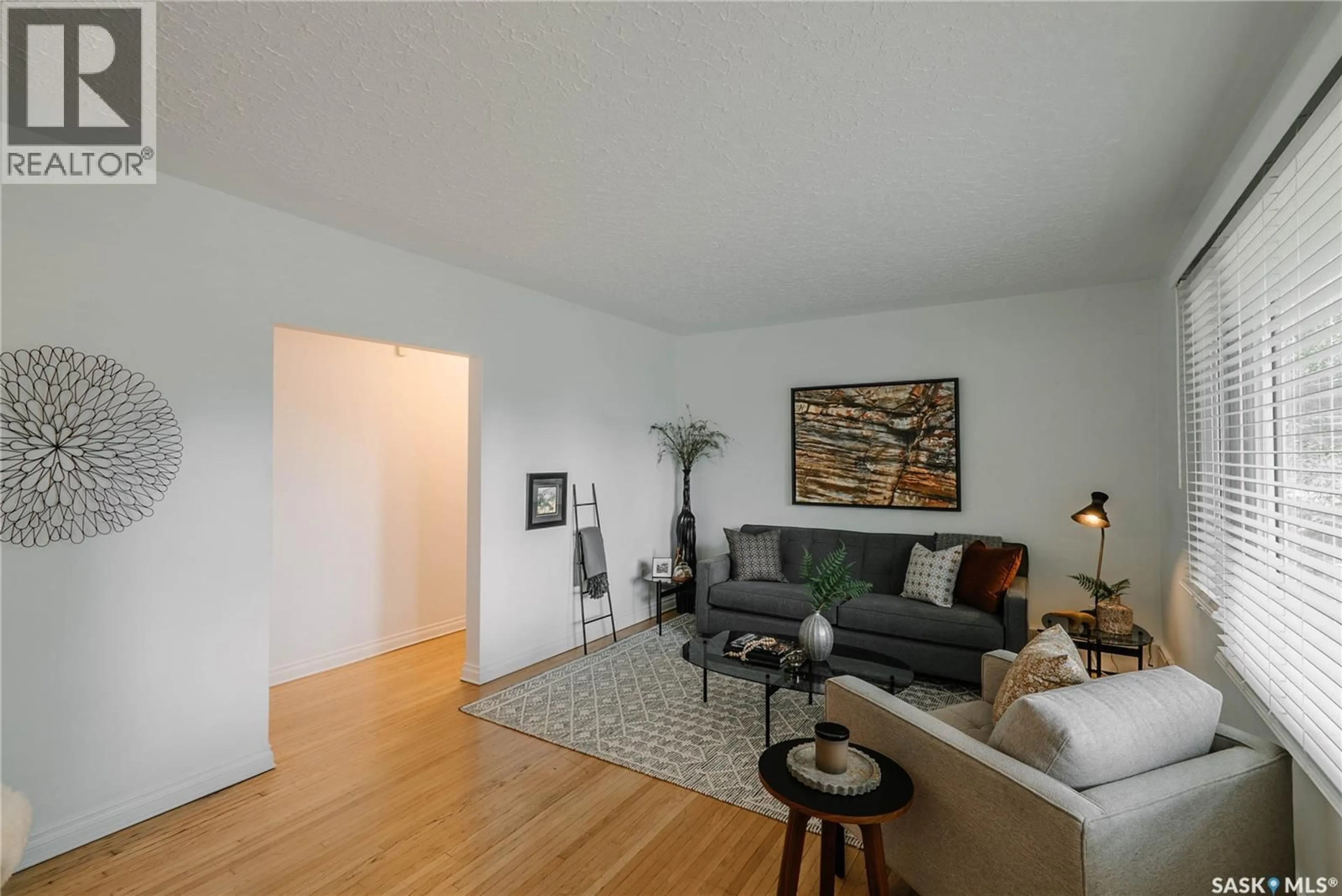 Living room with furniture, wood/laminate floor for 1012 2ND STREET E, Saskatoon Saskatchewan S7H1R3