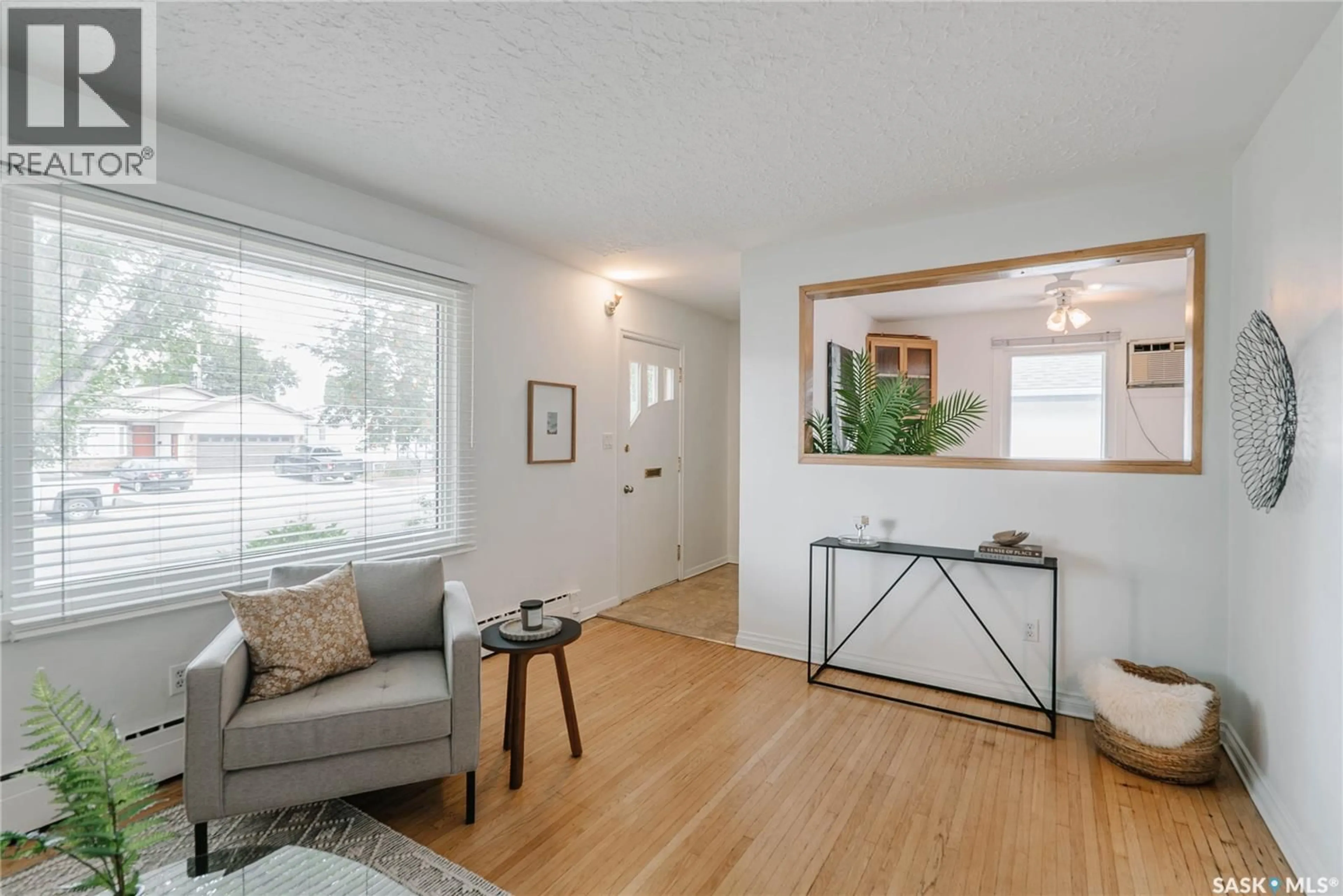 Living room with furniture, wood/laminate floor for 1012 2ND STREET E, Saskatoon Saskatchewan S7H1R3