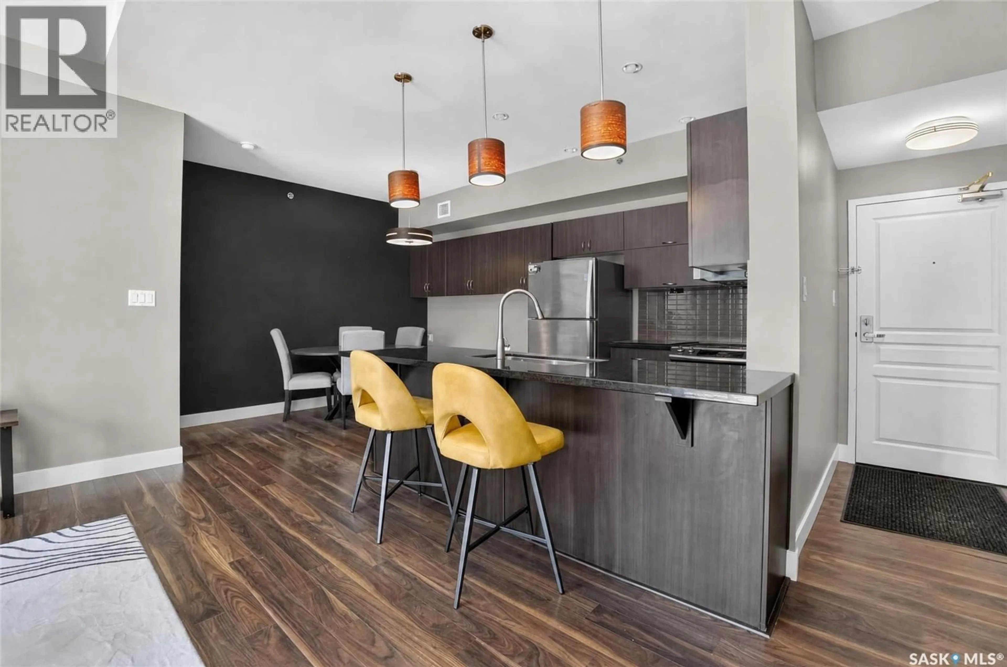 Open concept kitchen, wood/laminate floor for E - 302 721 8TH STREET, Saskatoon Saskatchewan S7H0R4