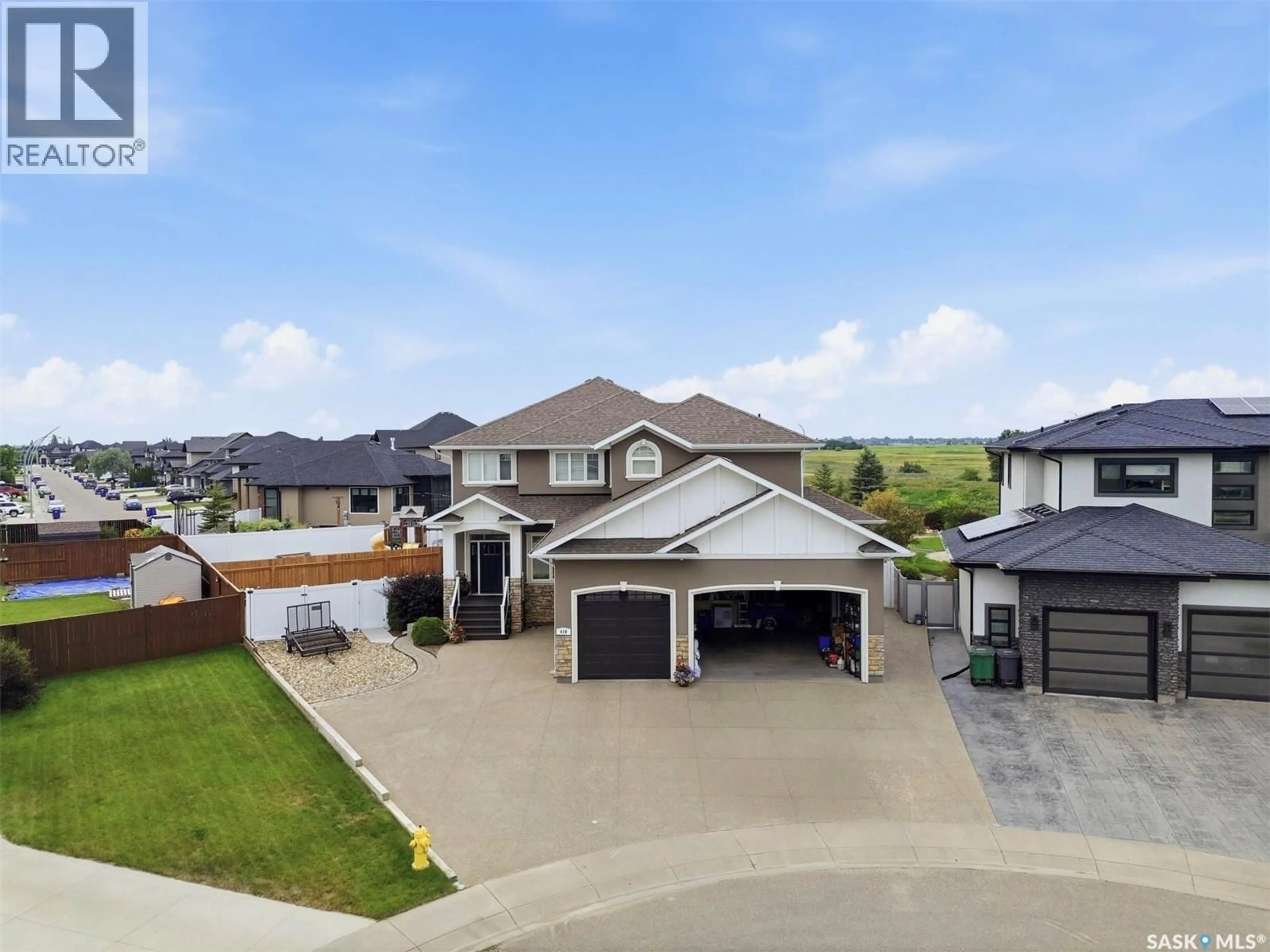 A pic from outside/outdoor area/front of a property/back of a property/a pic from drone, street for 419 SALLOUM BAY, Saskatoon Saskatchewan S7W0N1