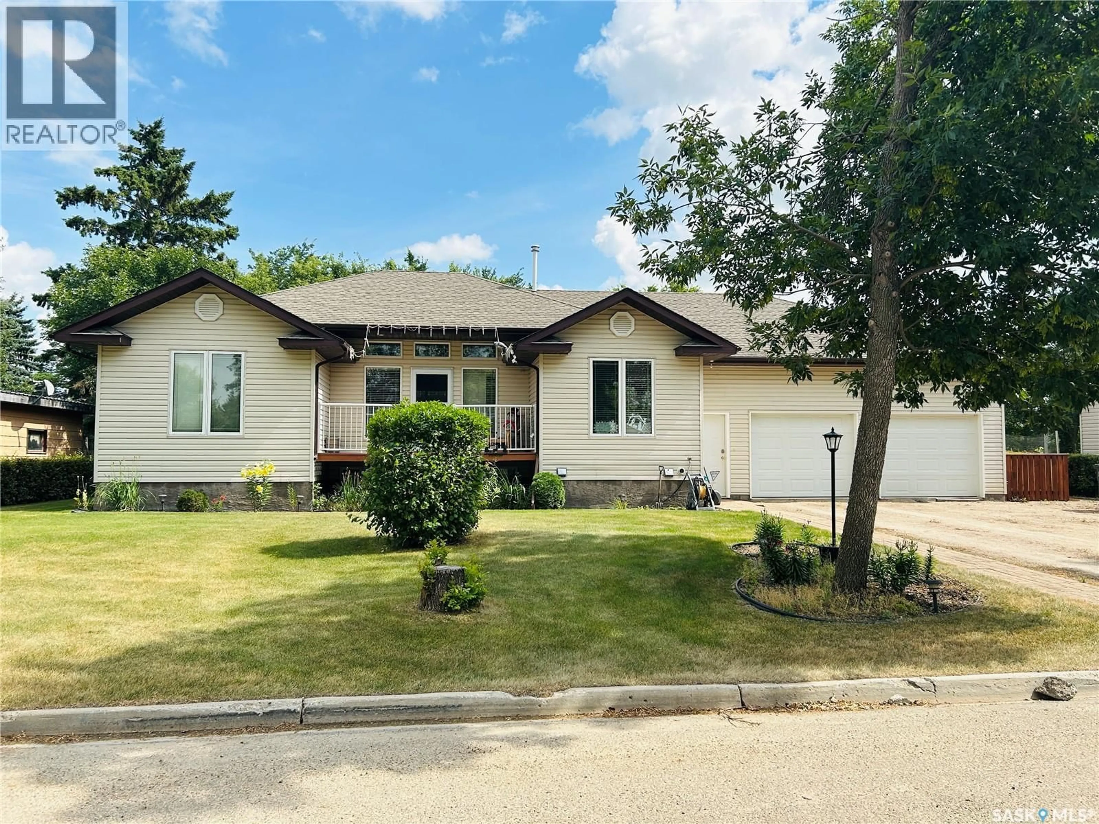 Home with vinyl exterior material, street for 214 3RD STREET, Watson Saskatchewan S0K4V0