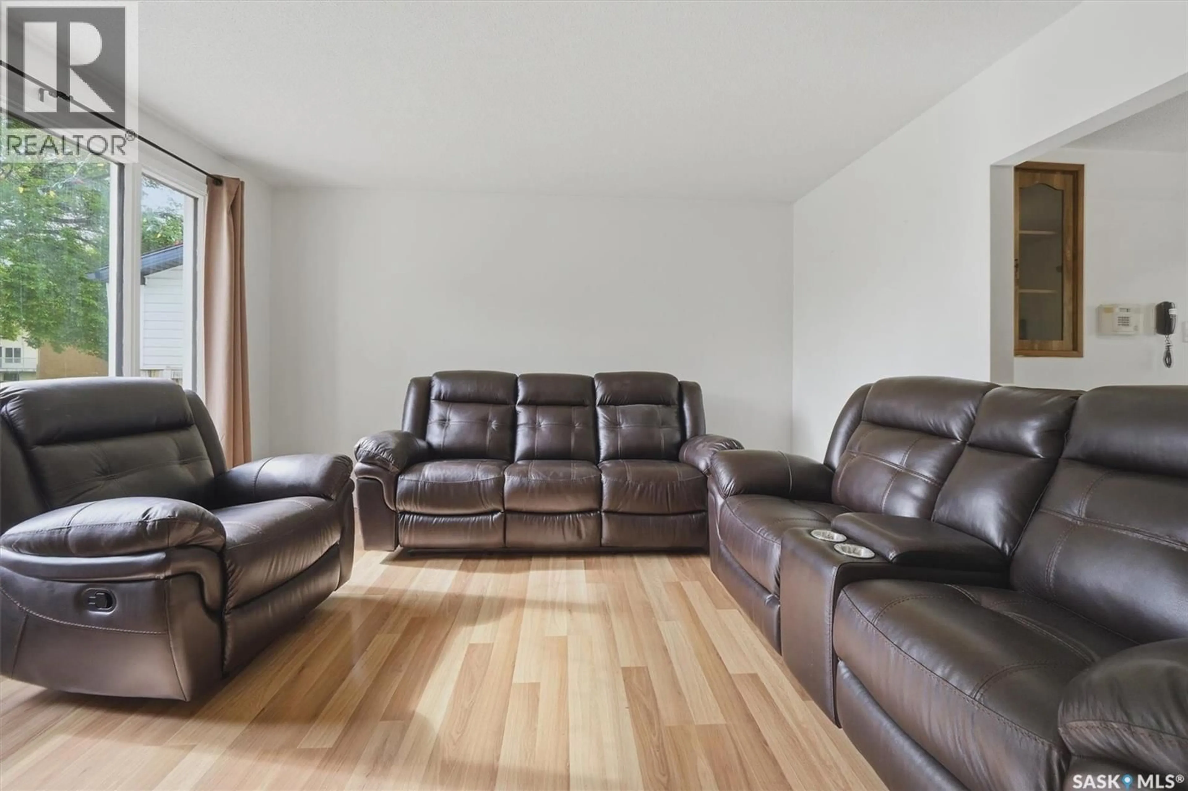 Living room with furniture, wood/laminate floor for 1305 W AVENUE N, Saskatoon Saskatchewan S7L3J2