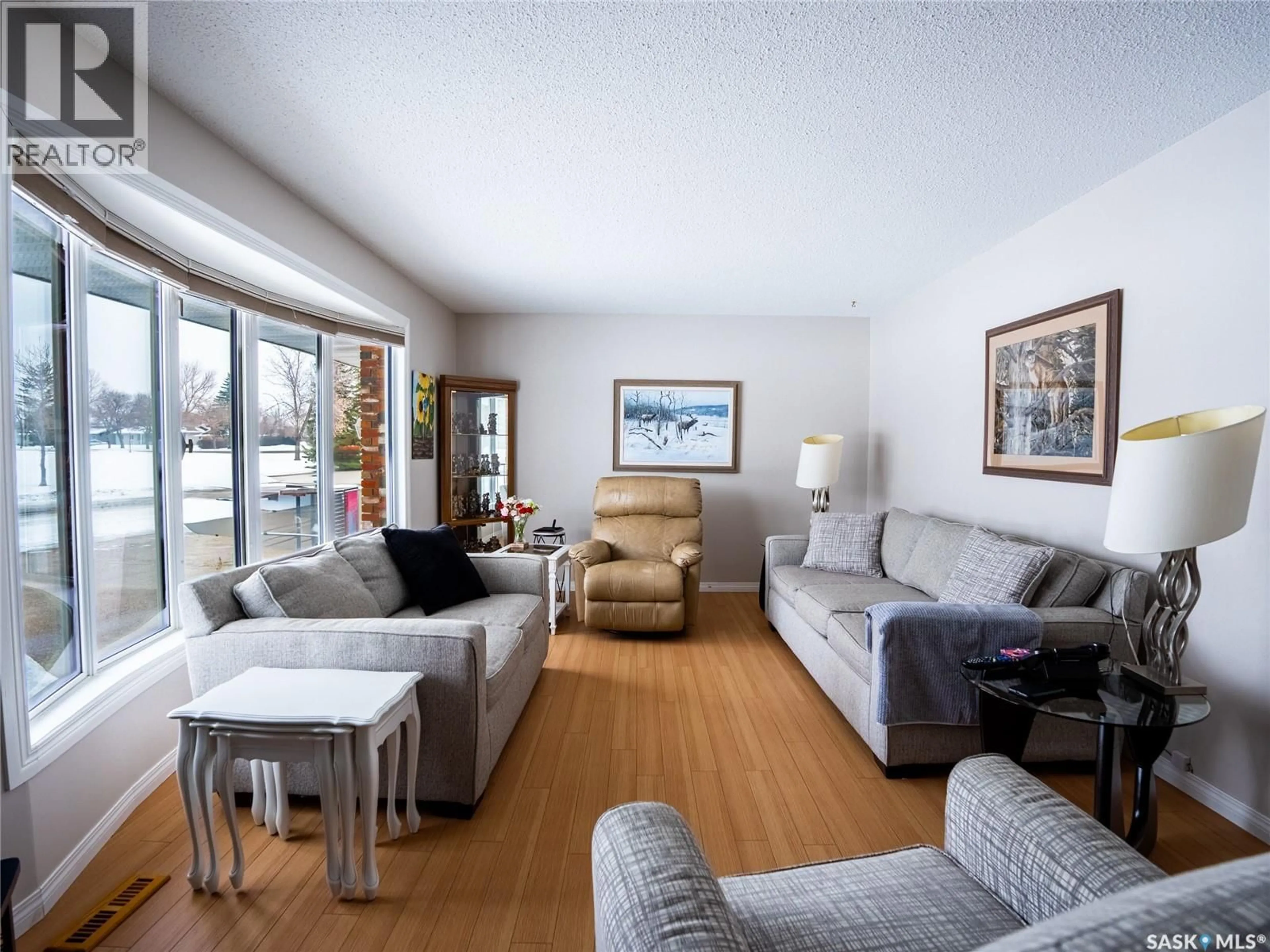 Living room with furniture, wood/laminate floor for 15 DICKINSON CRESCENT, Regina Saskatchewan S4R7K6
