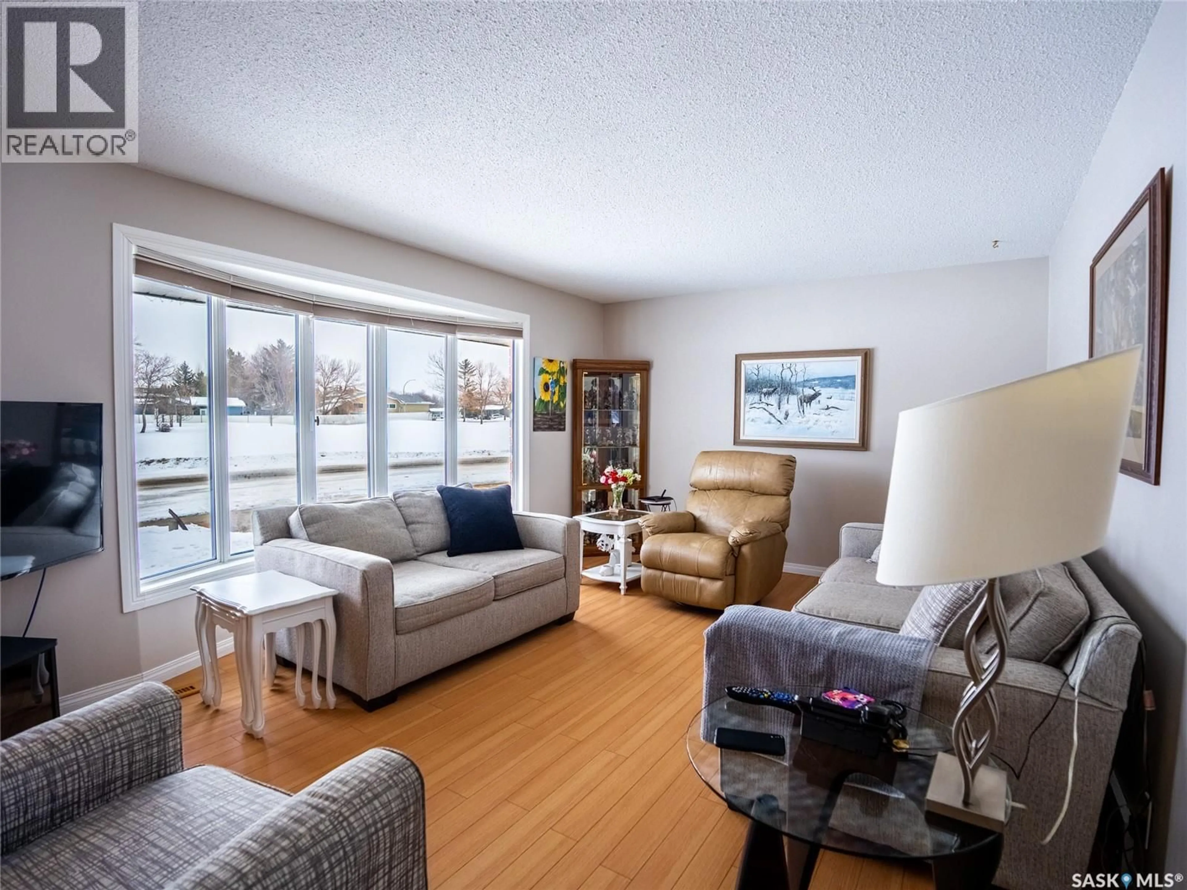 Living room with furniture, wood/laminate floor for 15 DICKINSON CRESCENT, Regina Saskatchewan S4R7K6