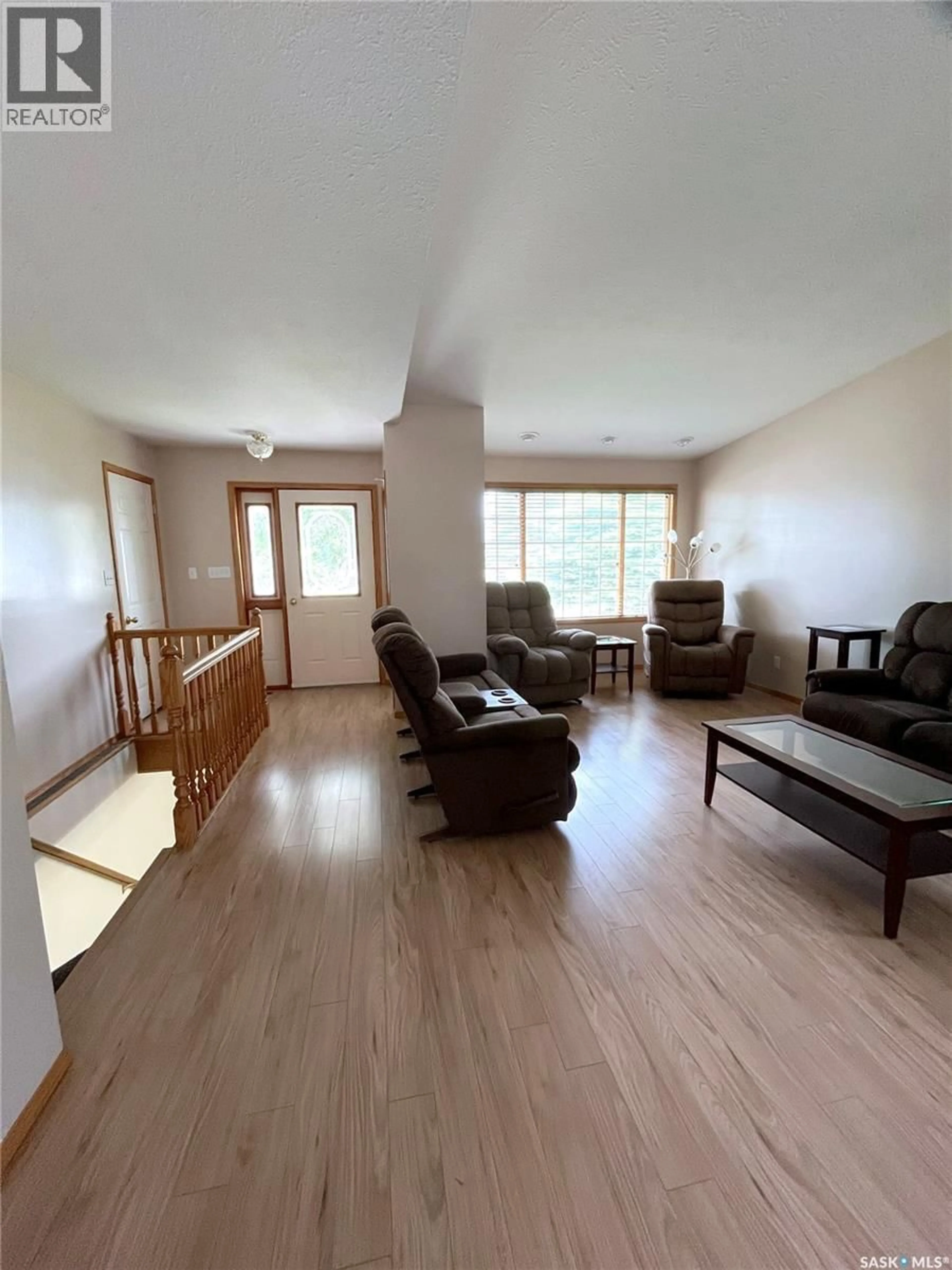 Living room with furniture, wood/laminate floor for 926 HENRY STREET, Estevan Saskatchewan S4A1N6