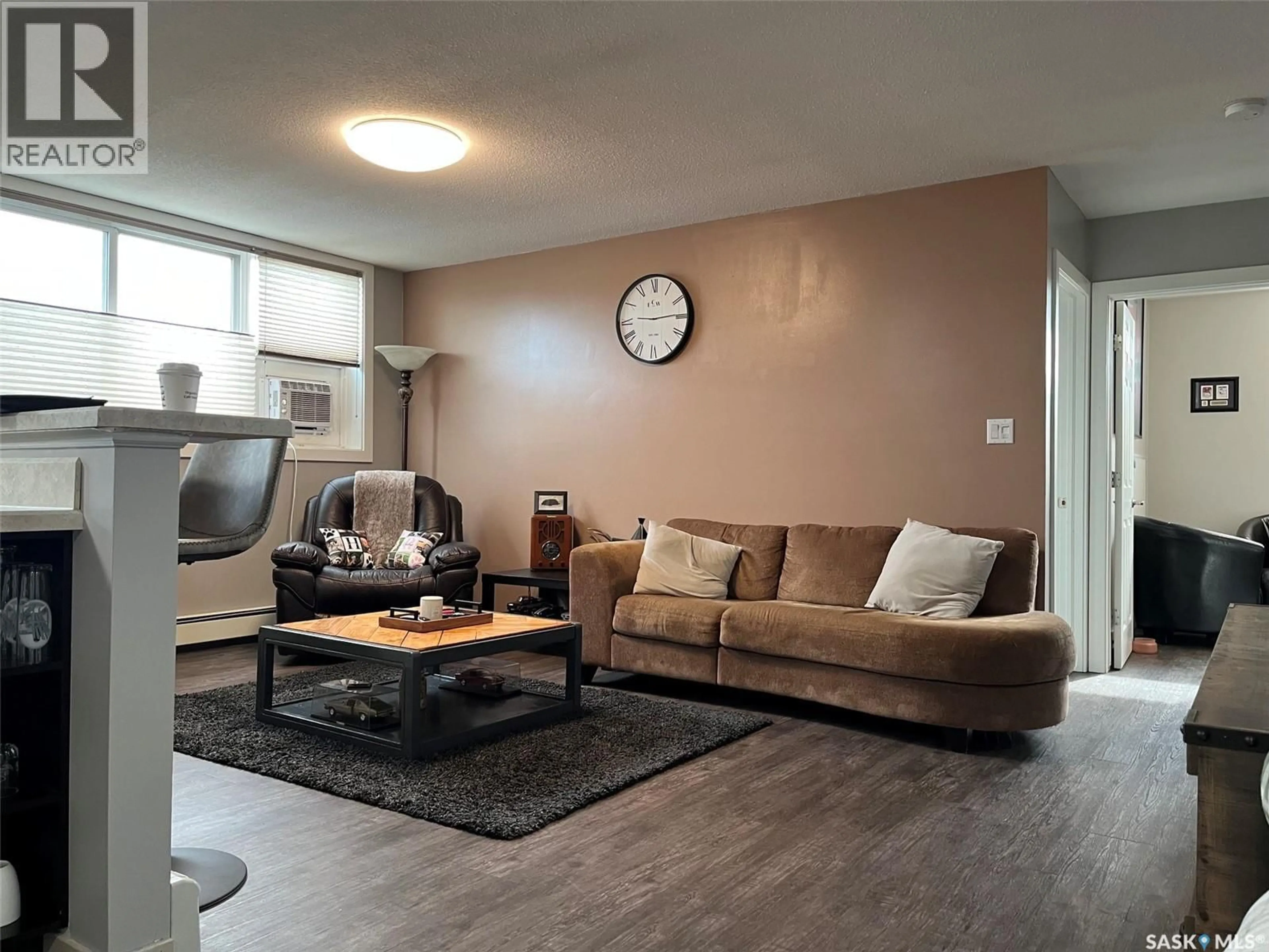 Living room with furniture, wood/laminate floor for 24 125 FROOM CRESCENT, Regina Saskatchewan S4N1S8