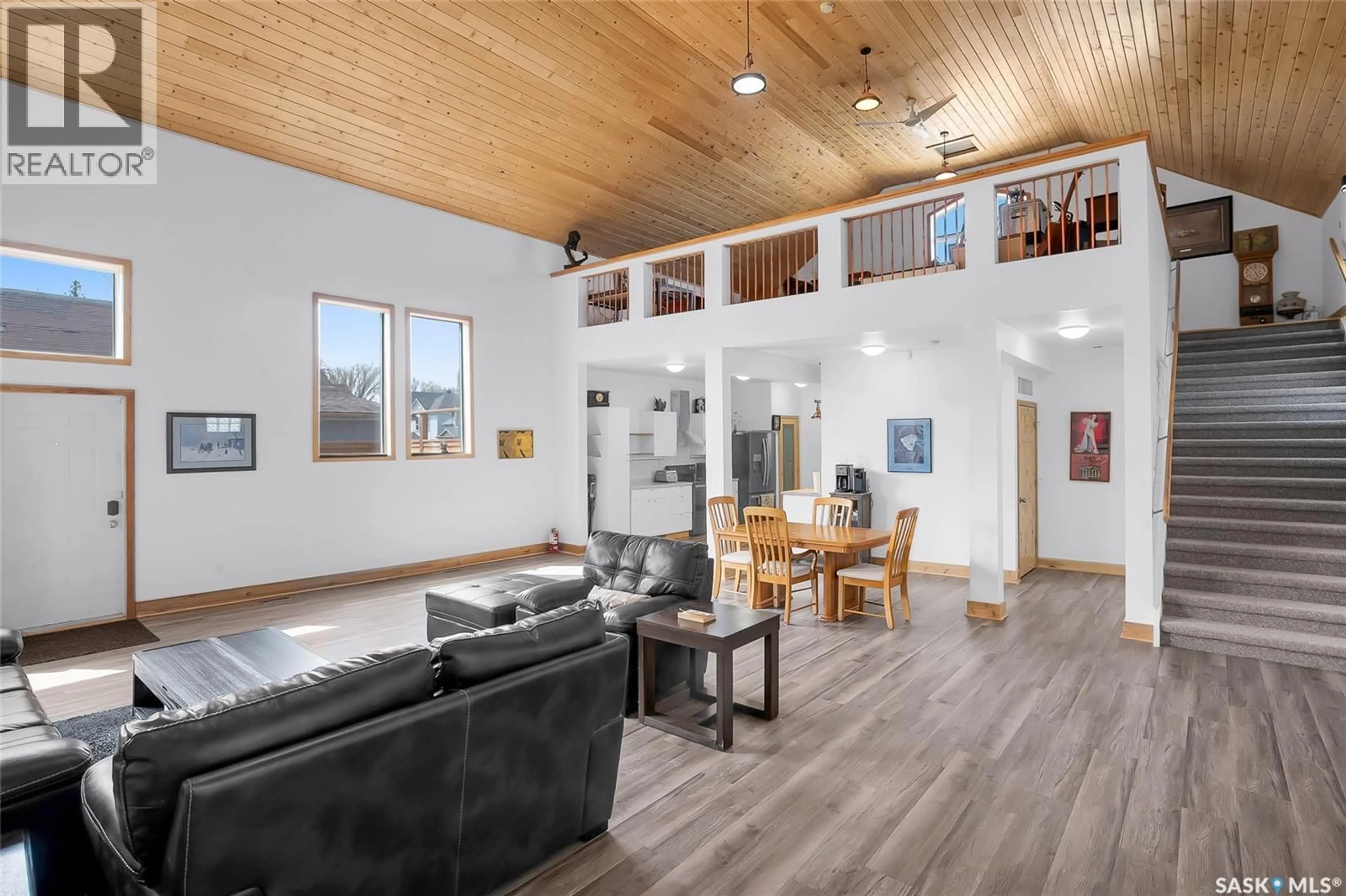 Living room with furniture, wood/laminate floor for 310 F AVENUE, Saskatoon Saskatchewan S7M1T2