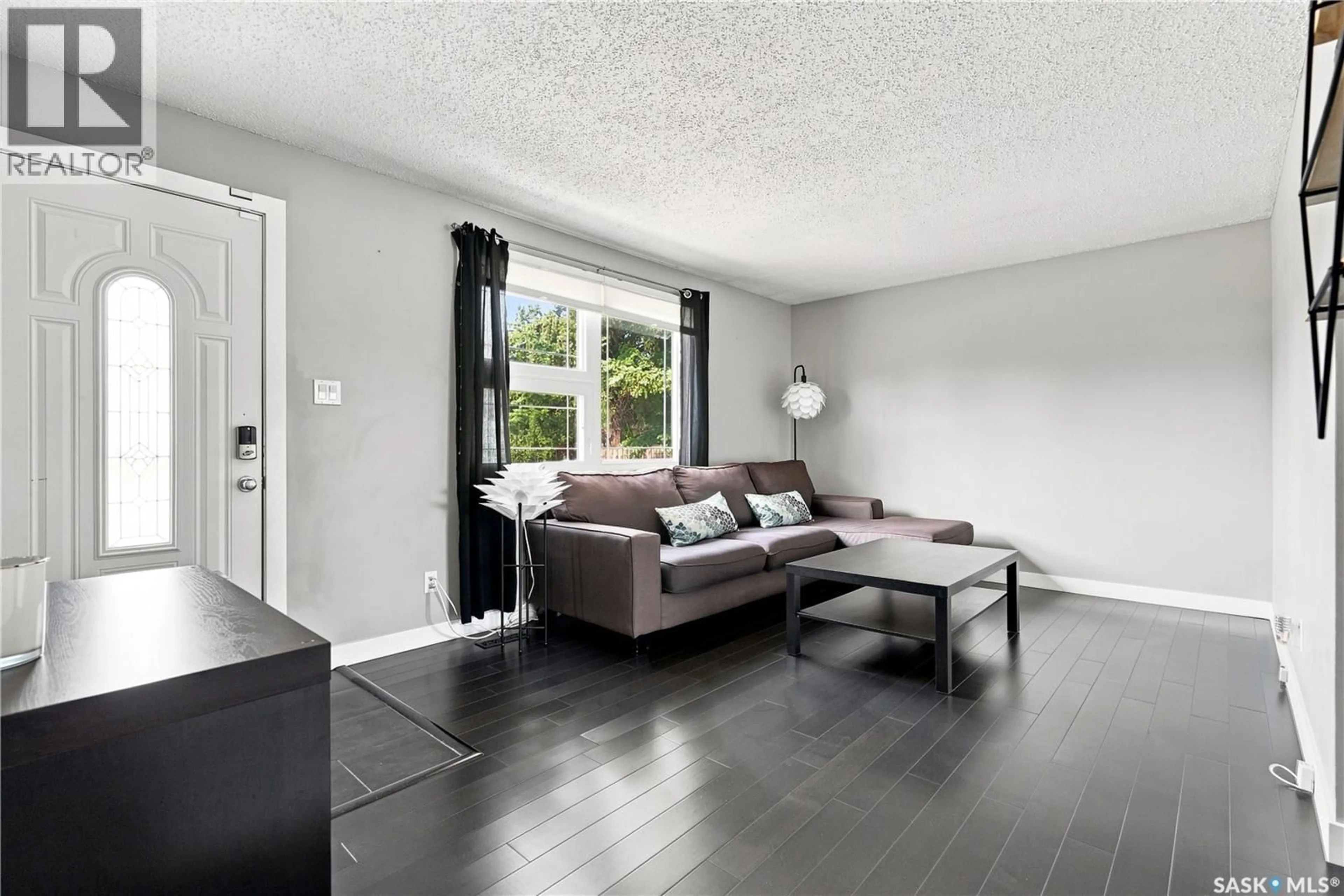 Living room with furniture, wood/laminate floor for 105 GRANT STREET, Saskatoon Saskatchewan S7N2A2