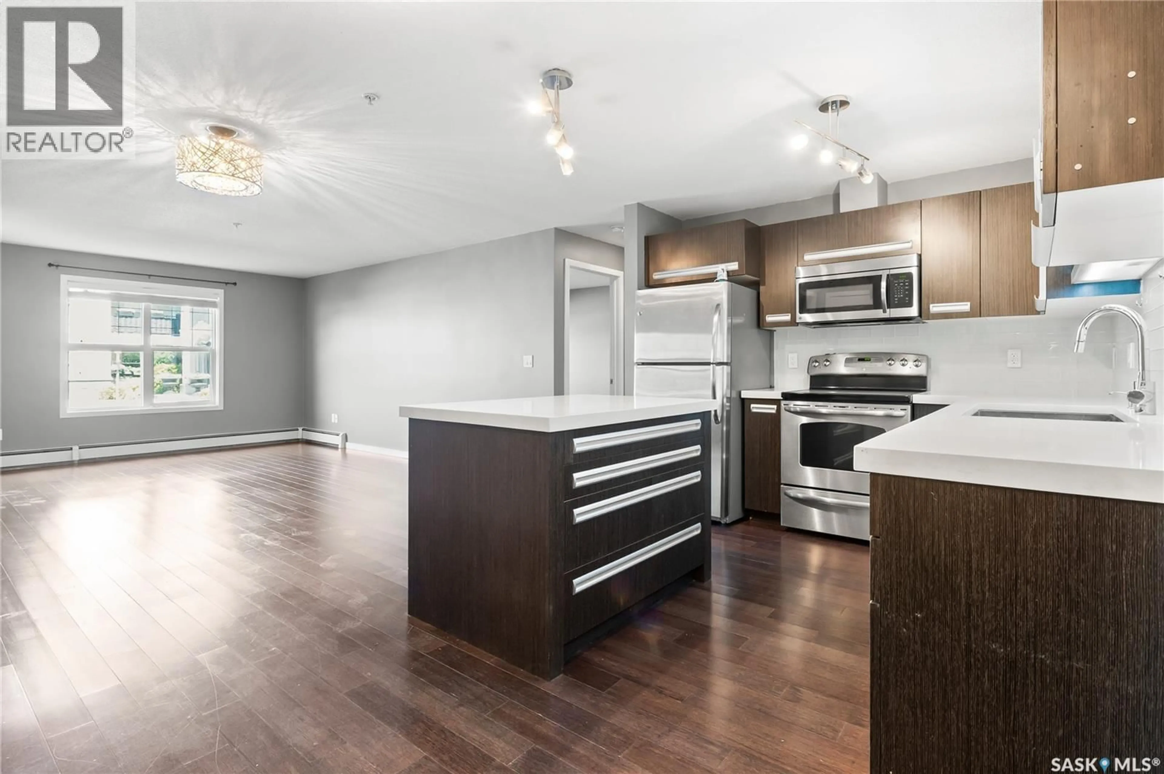 Open concept kitchen, wood/laminate floor for 117 1640 DAKOTA DRIVE, Regina Saskatchewan S4Z0A4
