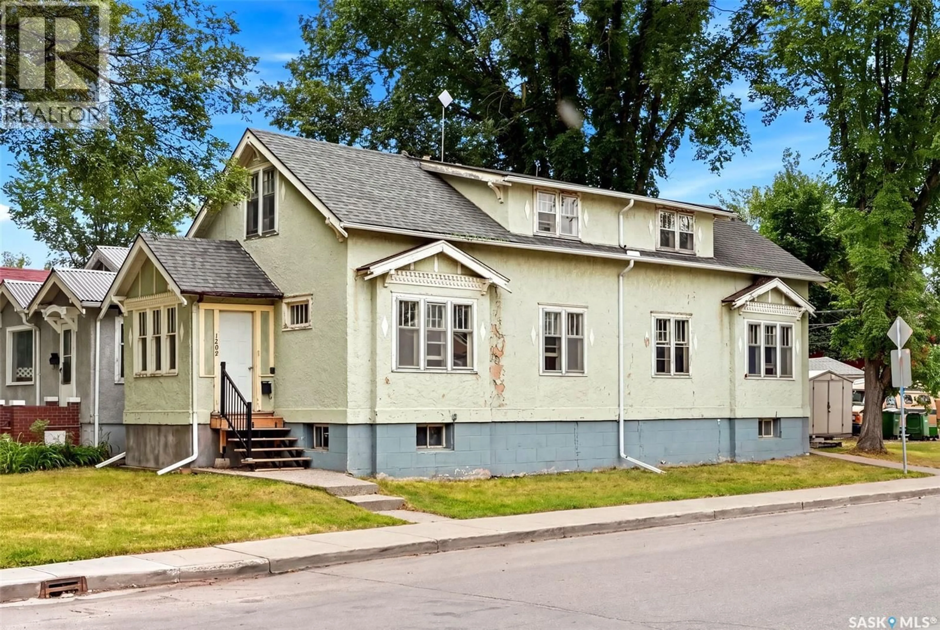 Home with vinyl exterior material, street for 1209 14TH AVENUE, Regina Saskatchewan S4P0W4
