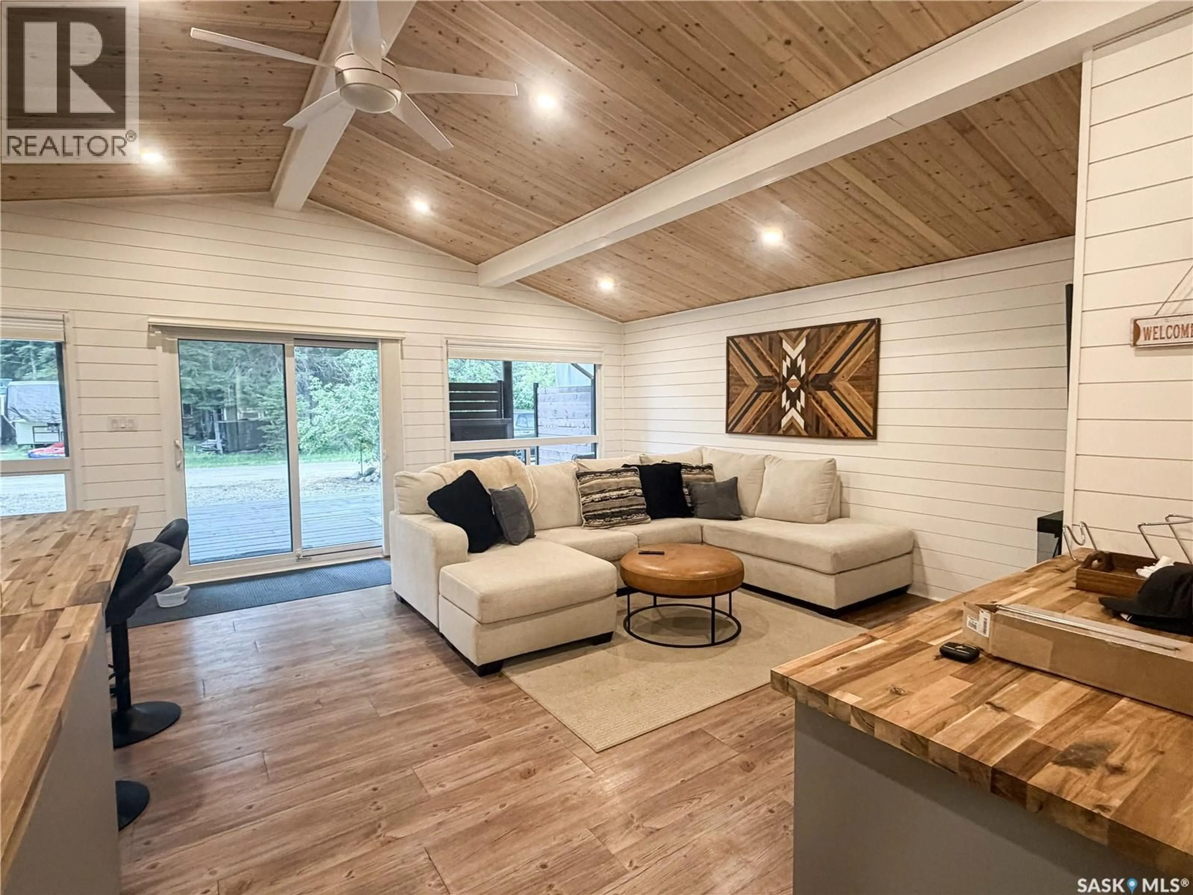 Living room with furniture, wood/laminate floor for 27 POPLAR STREET, Greig Lake Saskatchewan S0M0T0