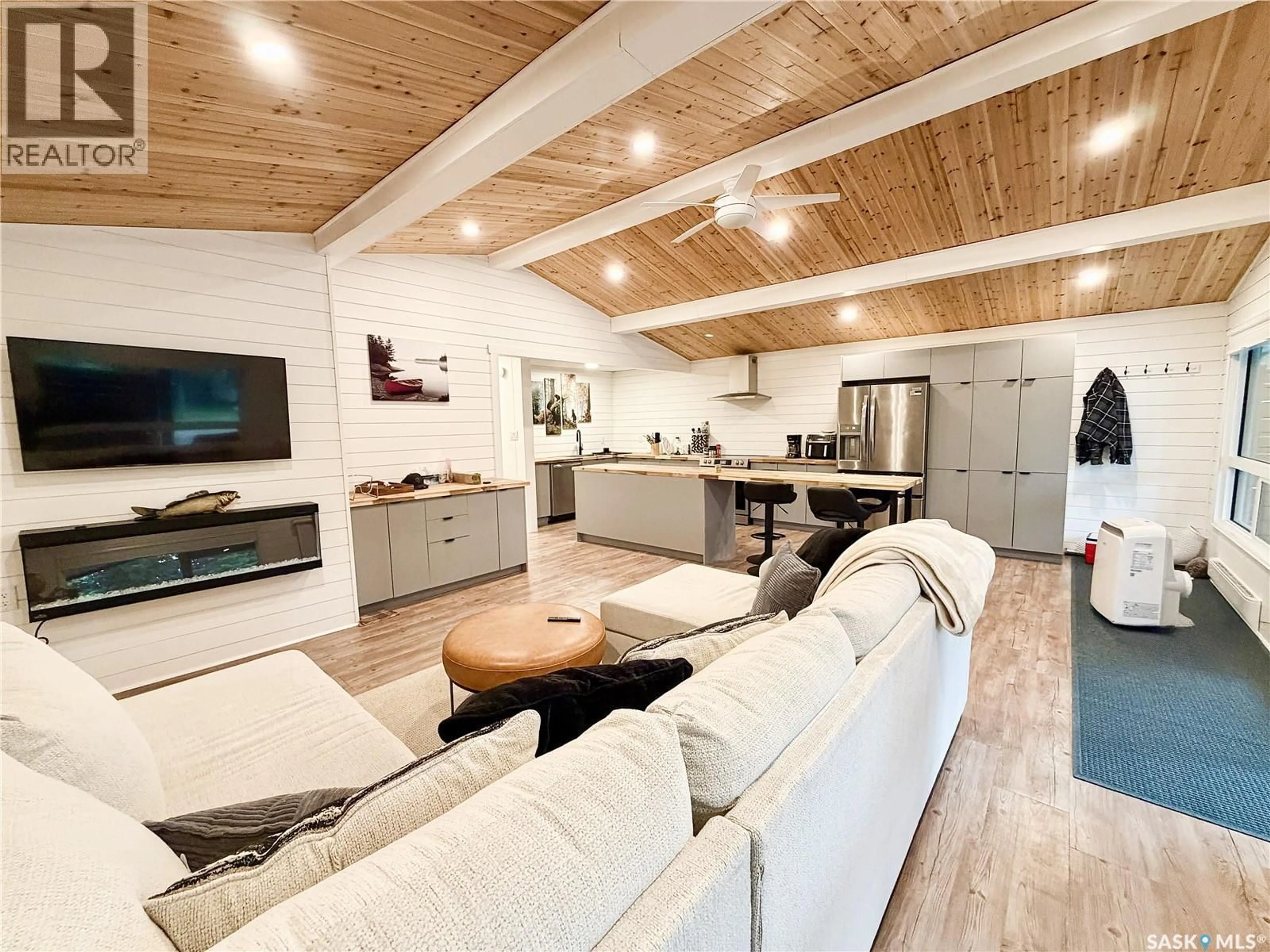 Living room with furniture, wood/laminate floor for 27 POPLAR STREET, Greig Lake Saskatchewan S0M0T0