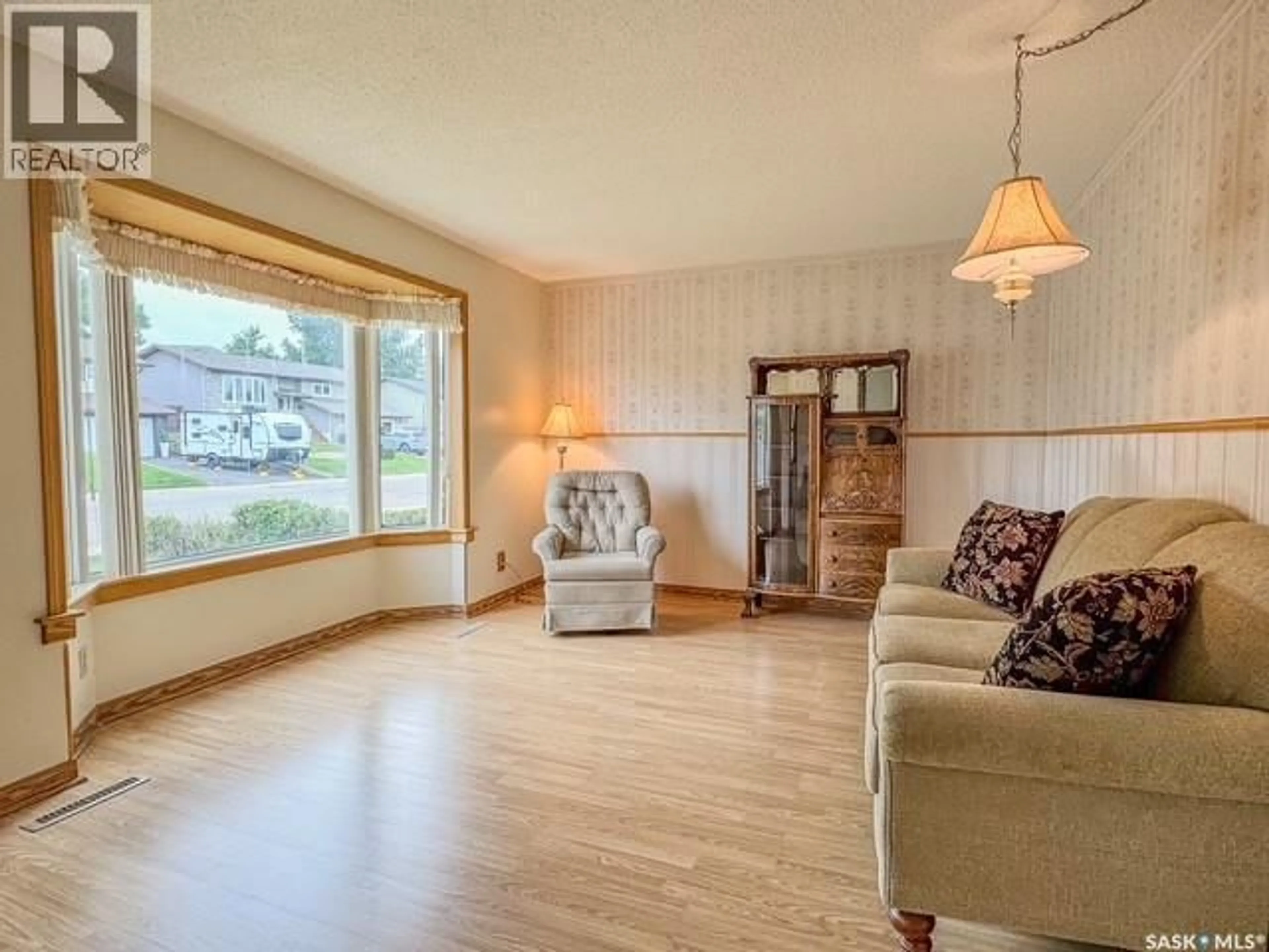 Living room with furniture, wood/laminate floor for 385 ASPEN DRIVE, Swift Current Saskatchewan S9H3Z8