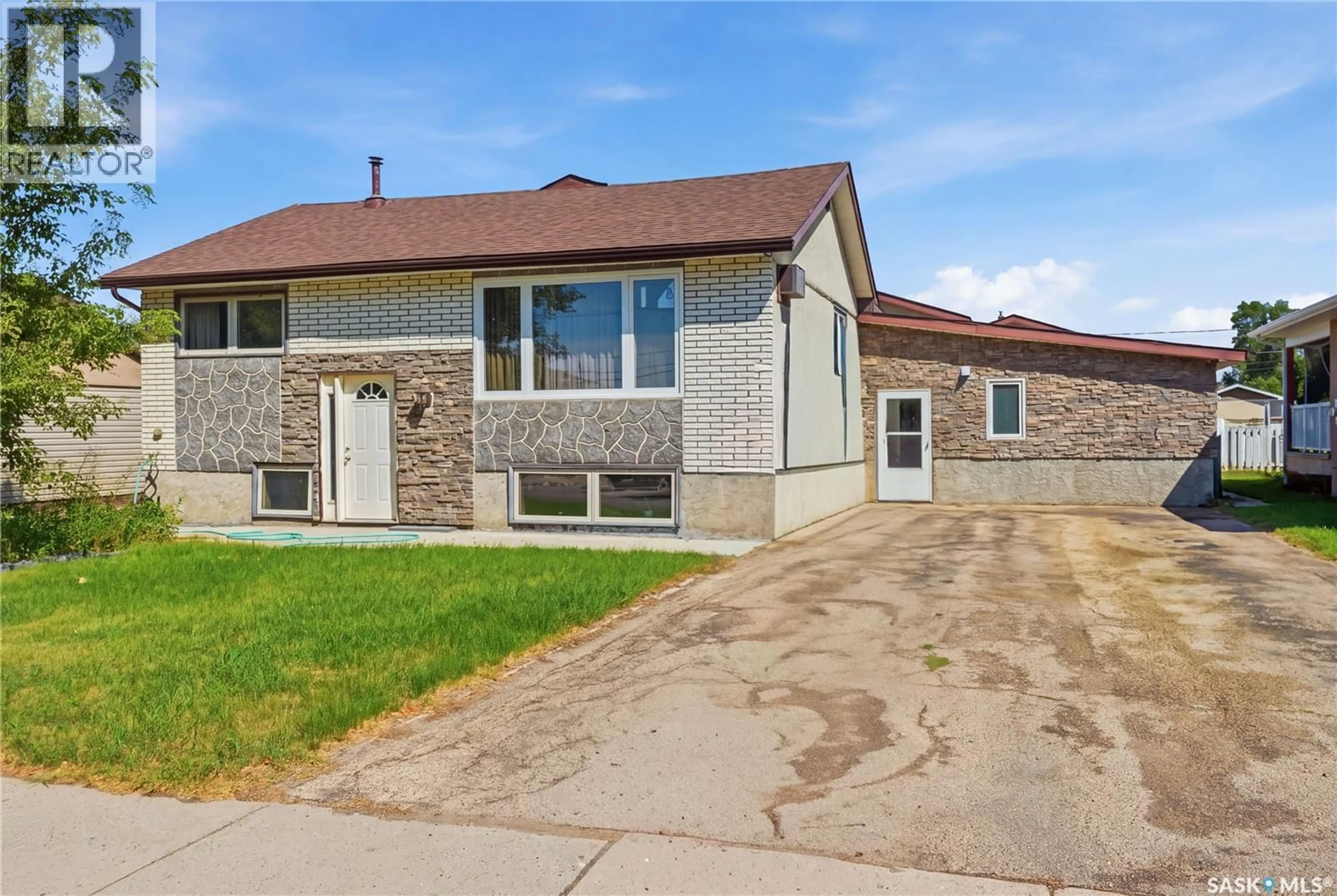 Home with brick exterior material, street for 1020 WARNER STREET, Moose Jaw Saskatchewan S6H5S5