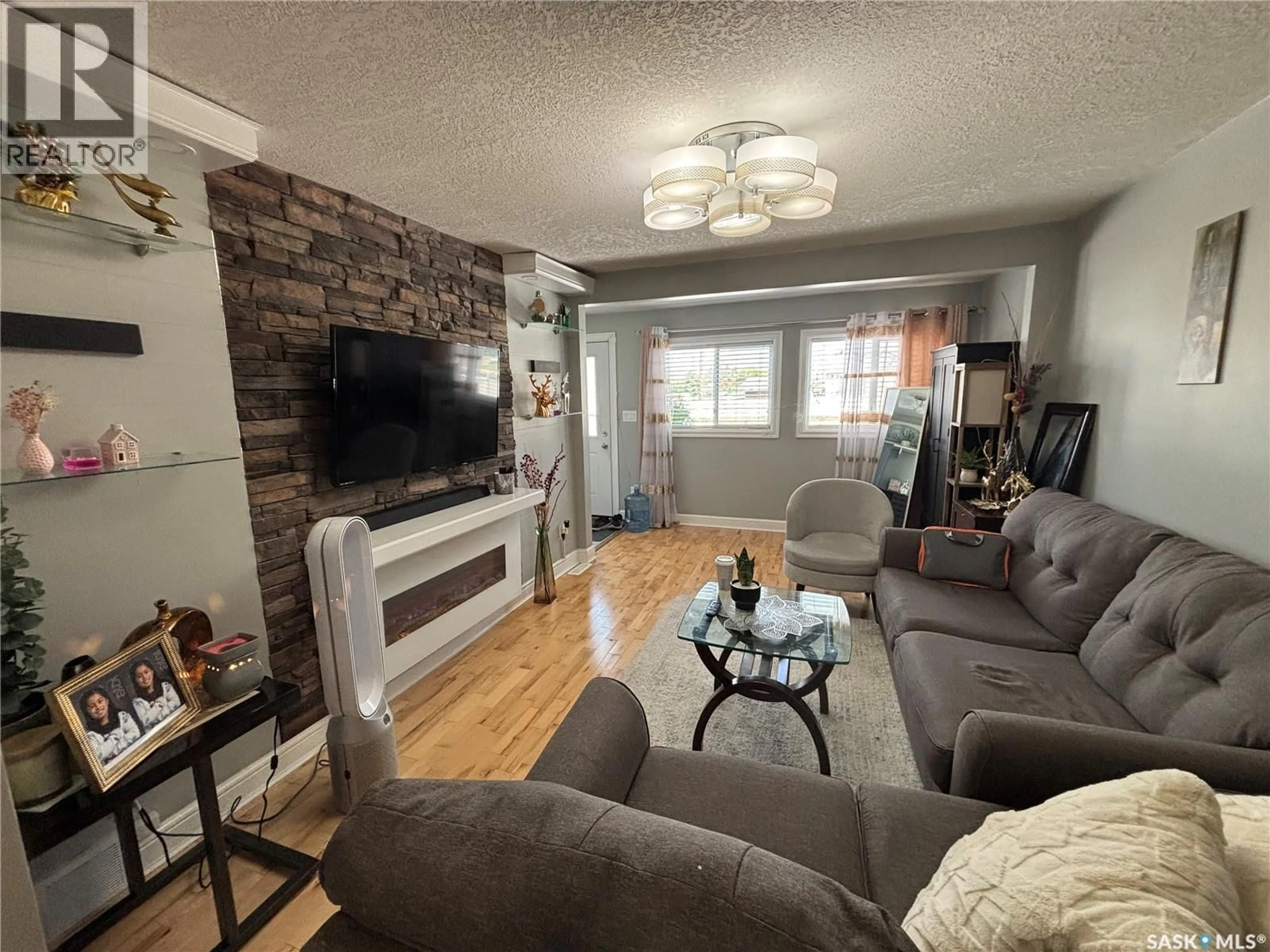 Living room with furniture, wood/laminate floor for 421 6TH AVENUE, Prince Albert Saskatchewan S6V2J2