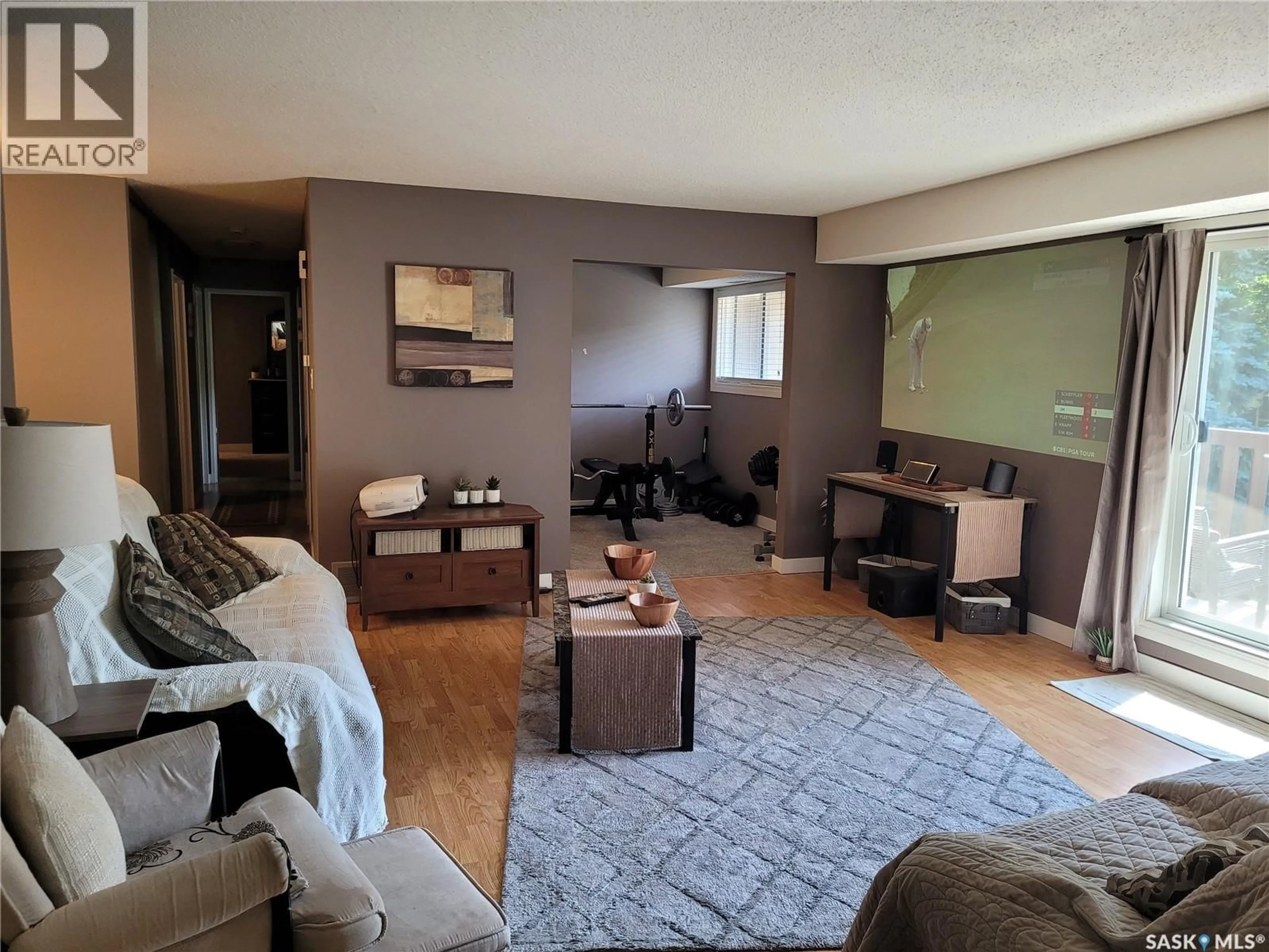 Living room with furniture, wood/laminate floor for 510 - 320 PRAIRIE AVENUE, Saskatoon Saskatchewan S7N2V4