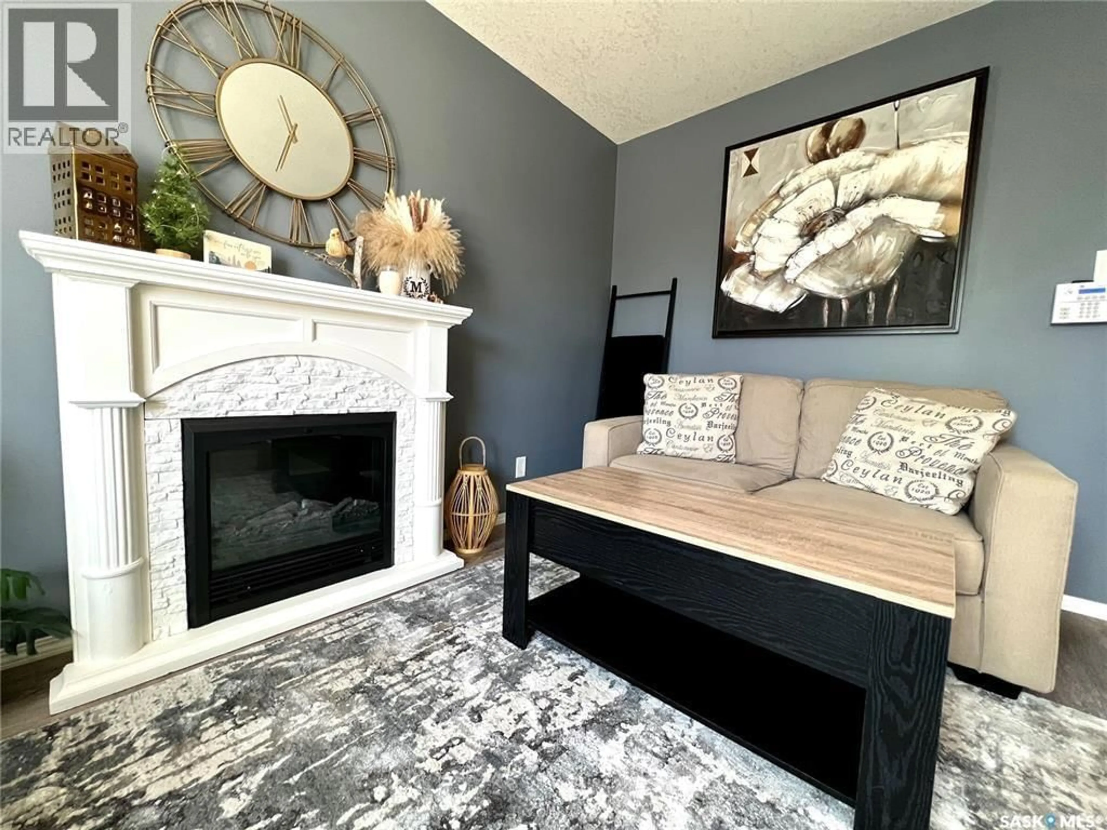 Living room with furniture, wood/laminate floor for 103 - 503 COLONEL OTTER DRIVE, Swift Current Saskatchewan S9H2K4