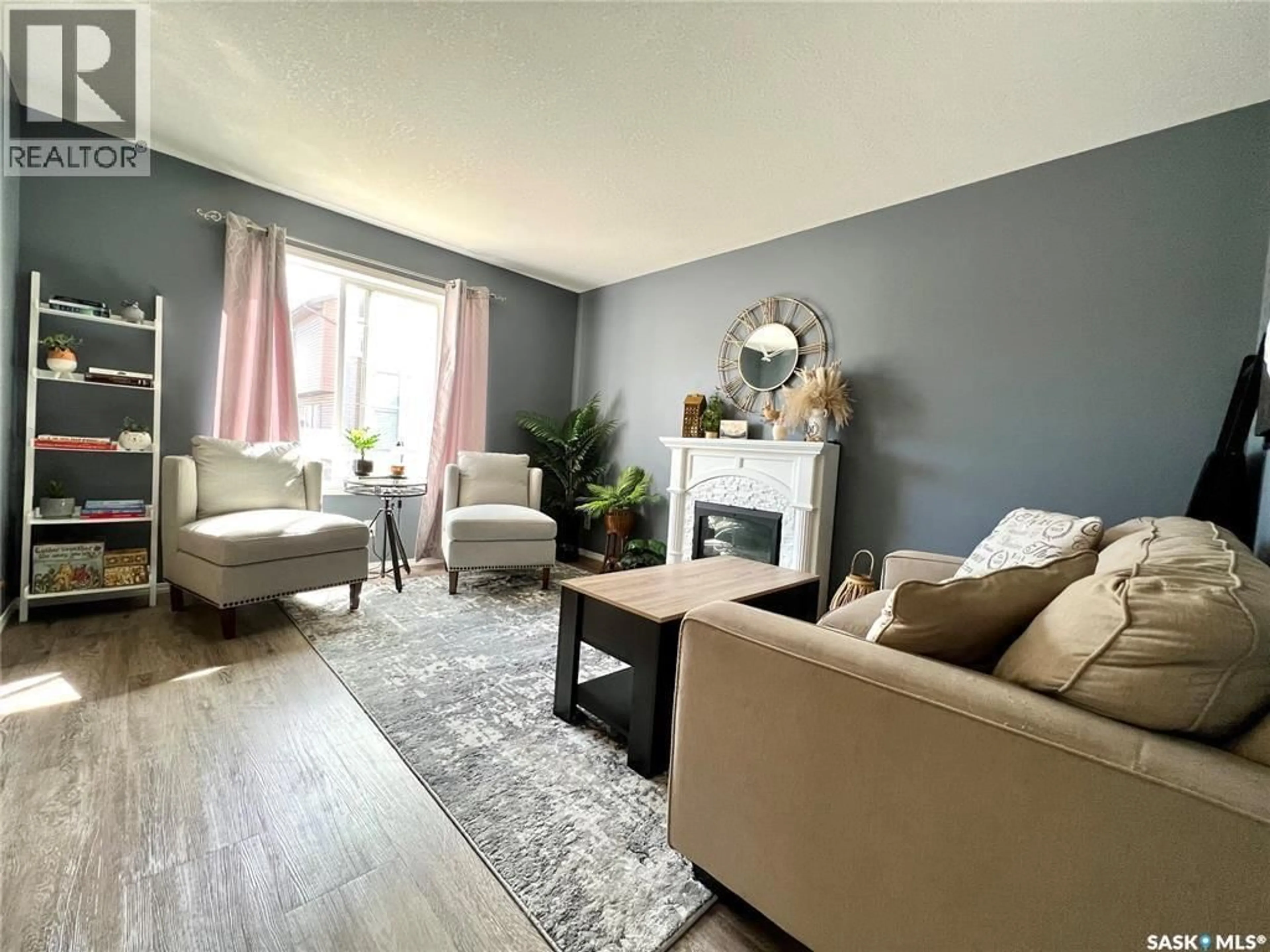 Living room with furniture, wood/laminate floor for 103 - 503 COLONEL OTTER DRIVE, Swift Current Saskatchewan S9H2K4