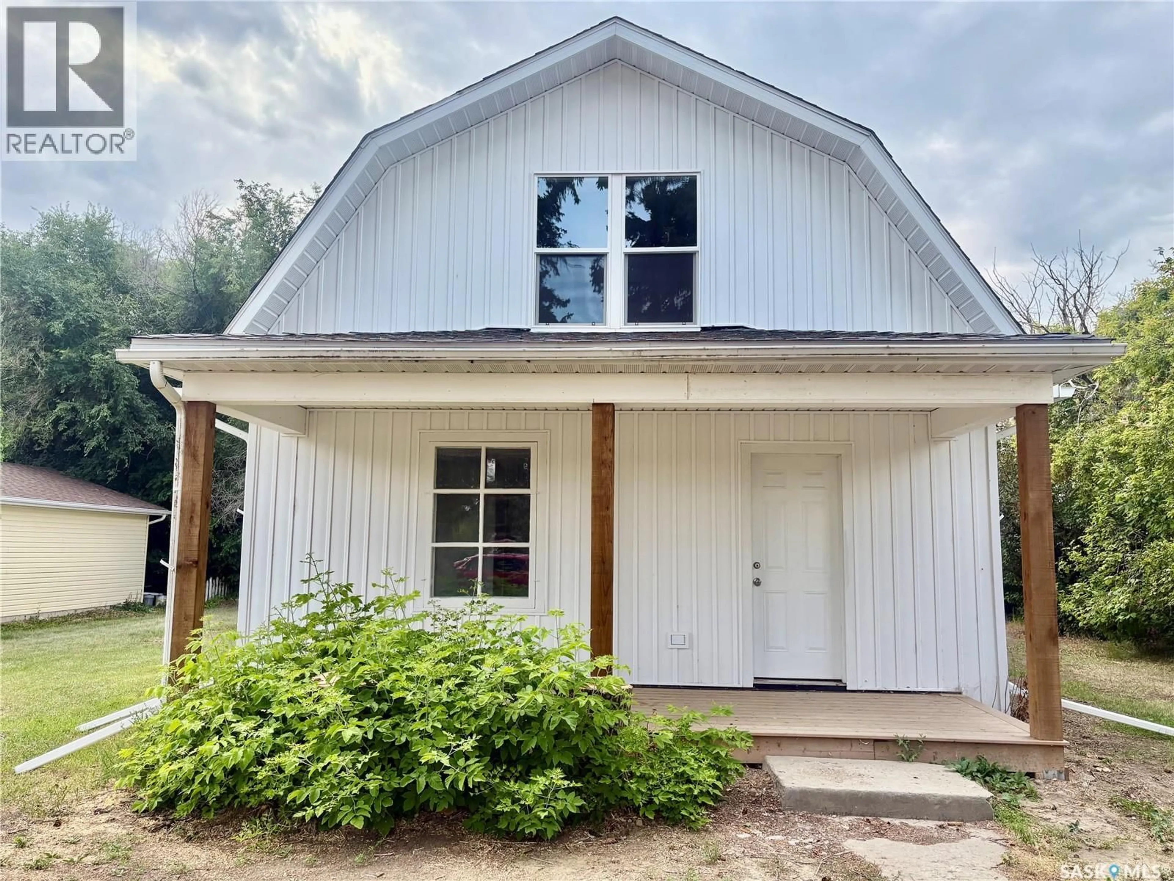 Home with vinyl exterior material, street for 214 THOMSON STREET, Outlook Saskatchewan S0L2N0