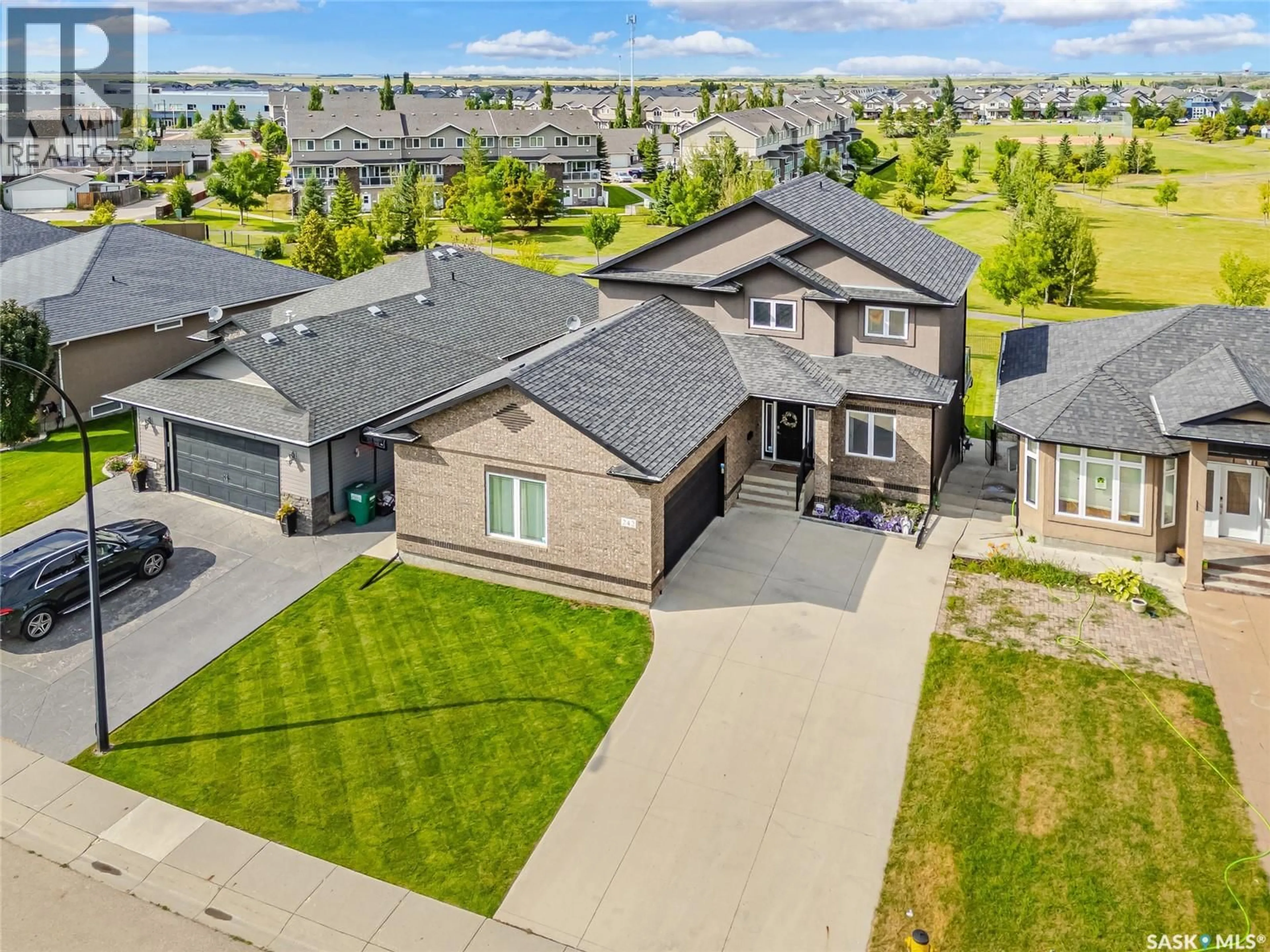 A pic from outside/outdoor area/front of a property/back of a property/a pic from drone, street for 242 DENHAM CRESCENT, Saskatoon Saskatchewan S7R1E9