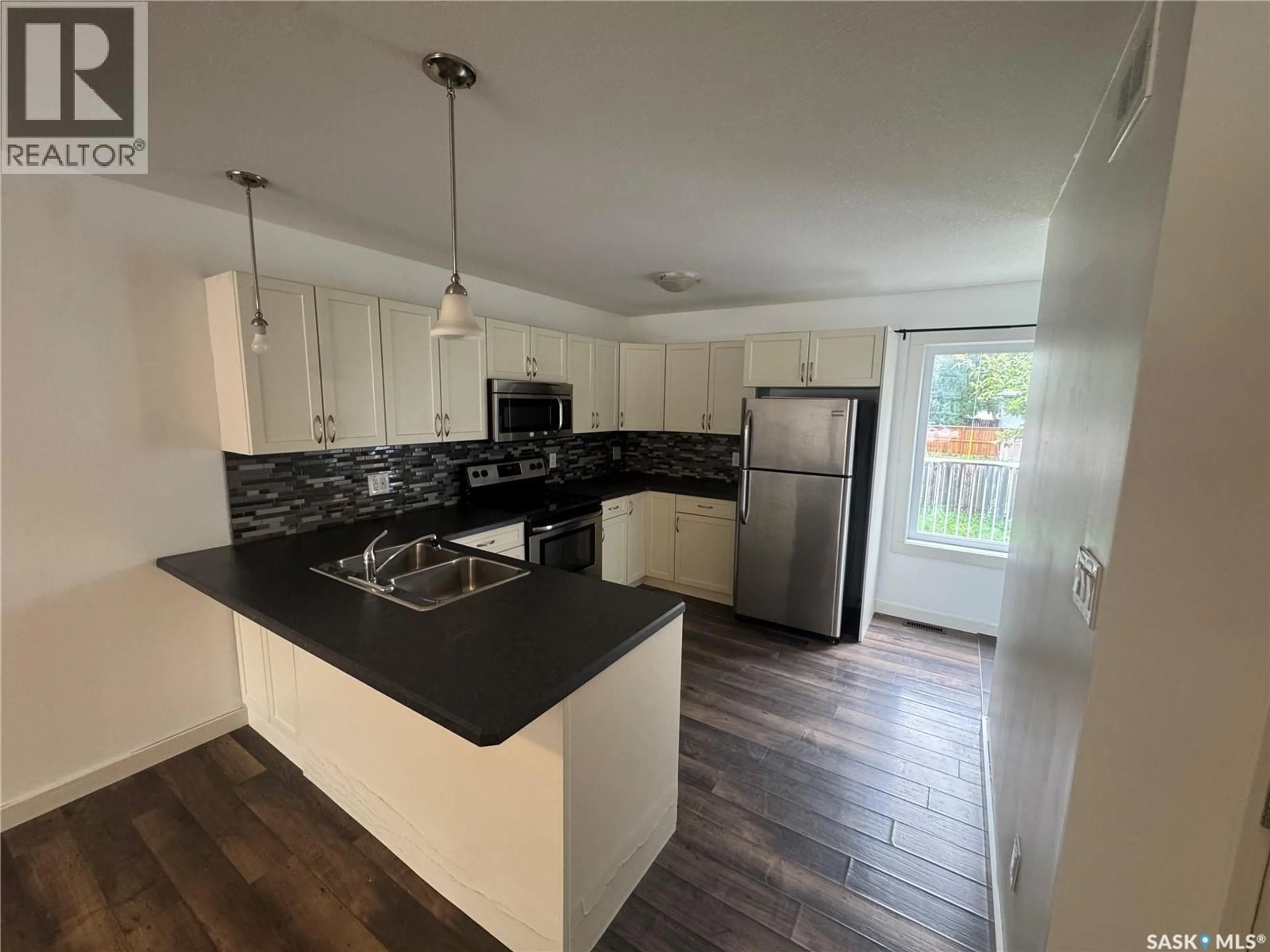 Open concept kitchen, wood/laminate floor for 55 ALEXANDRA STREET, Weyburn Saskatchewan S4H1R7