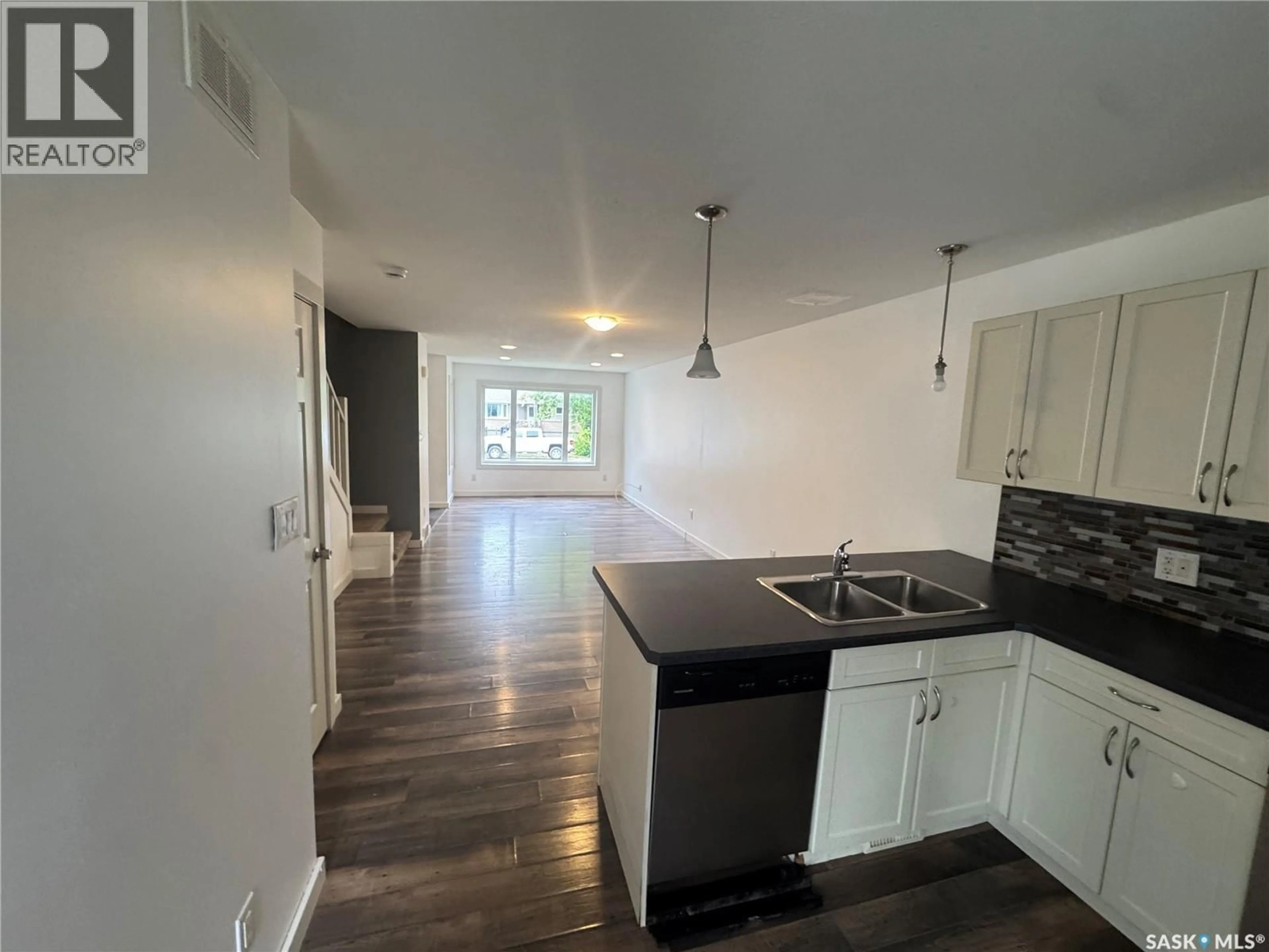 Open concept kitchen, wood/laminate floor for 55 ALEXANDRA STREET, Weyburn Saskatchewan S4H1R7