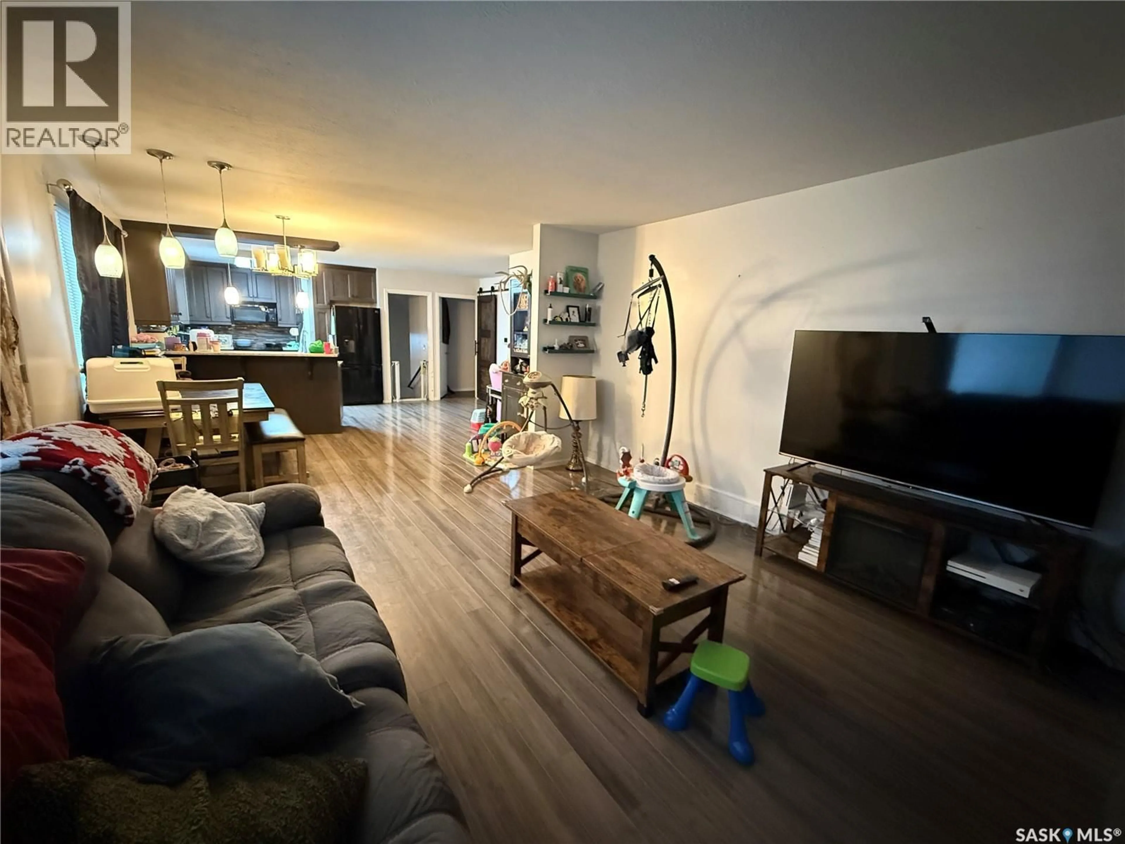 Living room with furniture, wood/laminate floor for 1141 HARTNEY AVENUE, Weyburn Saskatchewan S4H0L9