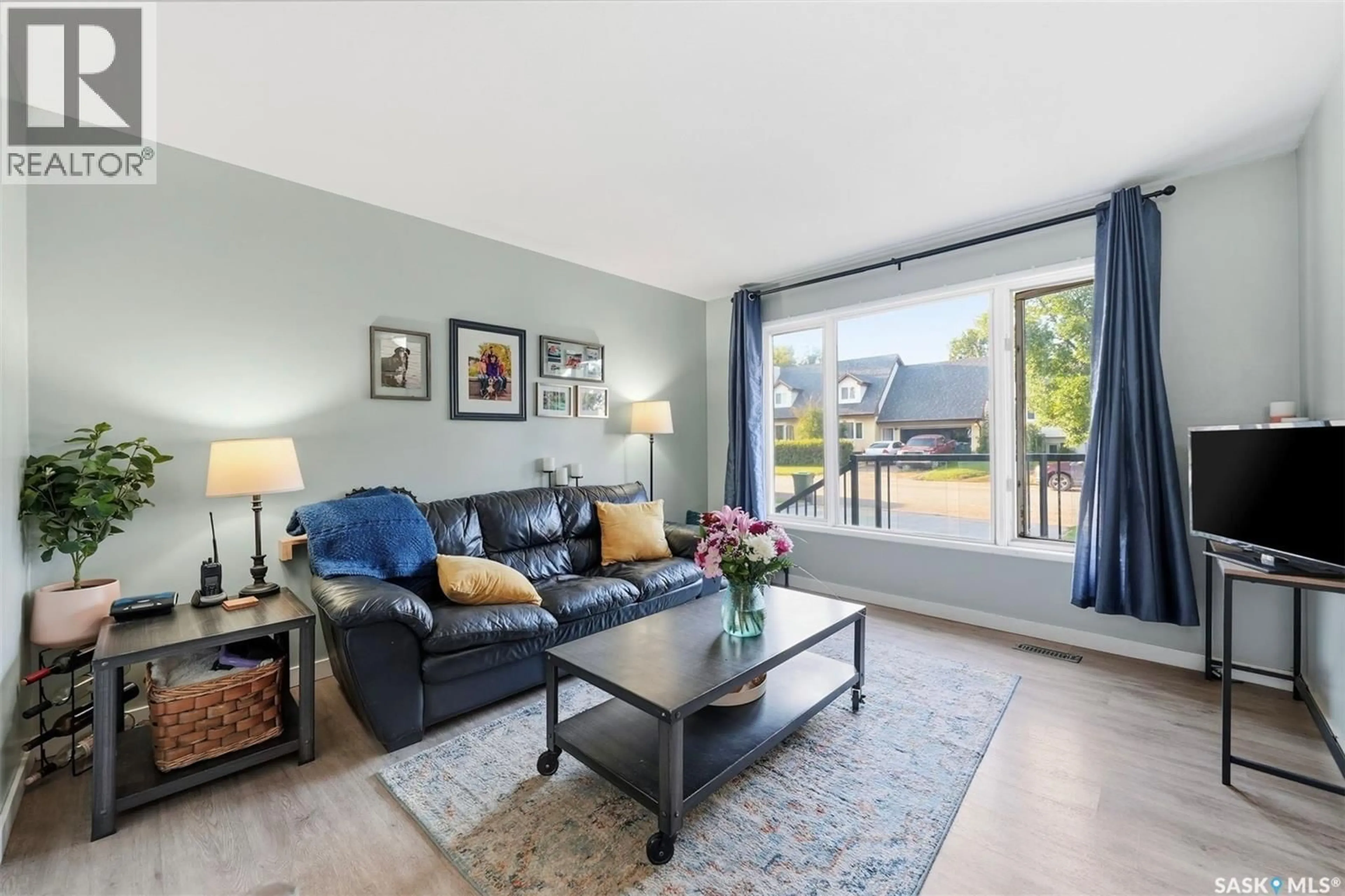 Living room with furniture, wood/laminate floor for 311 LOEPPKY AVENUE, Dalmeny Saskatchewan S0K1E0