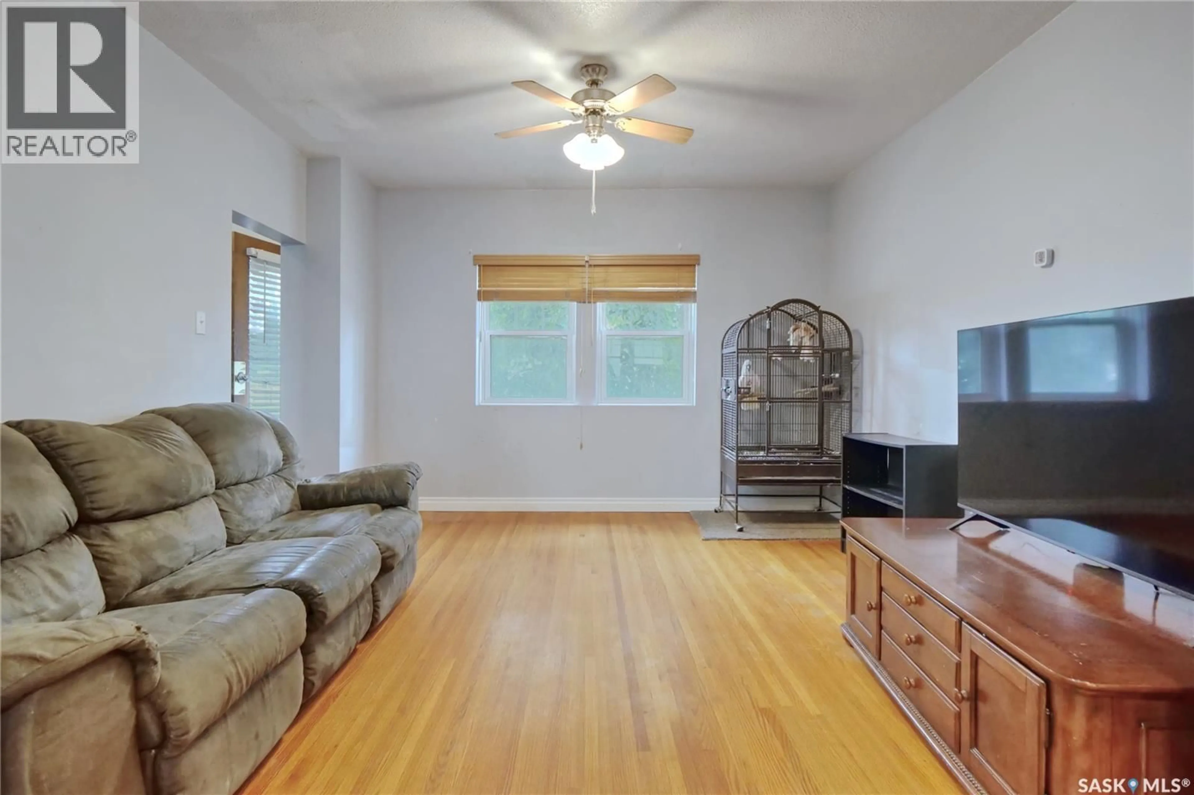 Living room with furniture, wood/laminate floor for 70 CARIBOU STREET, Moose Jaw Saskatchewan S6H0R3