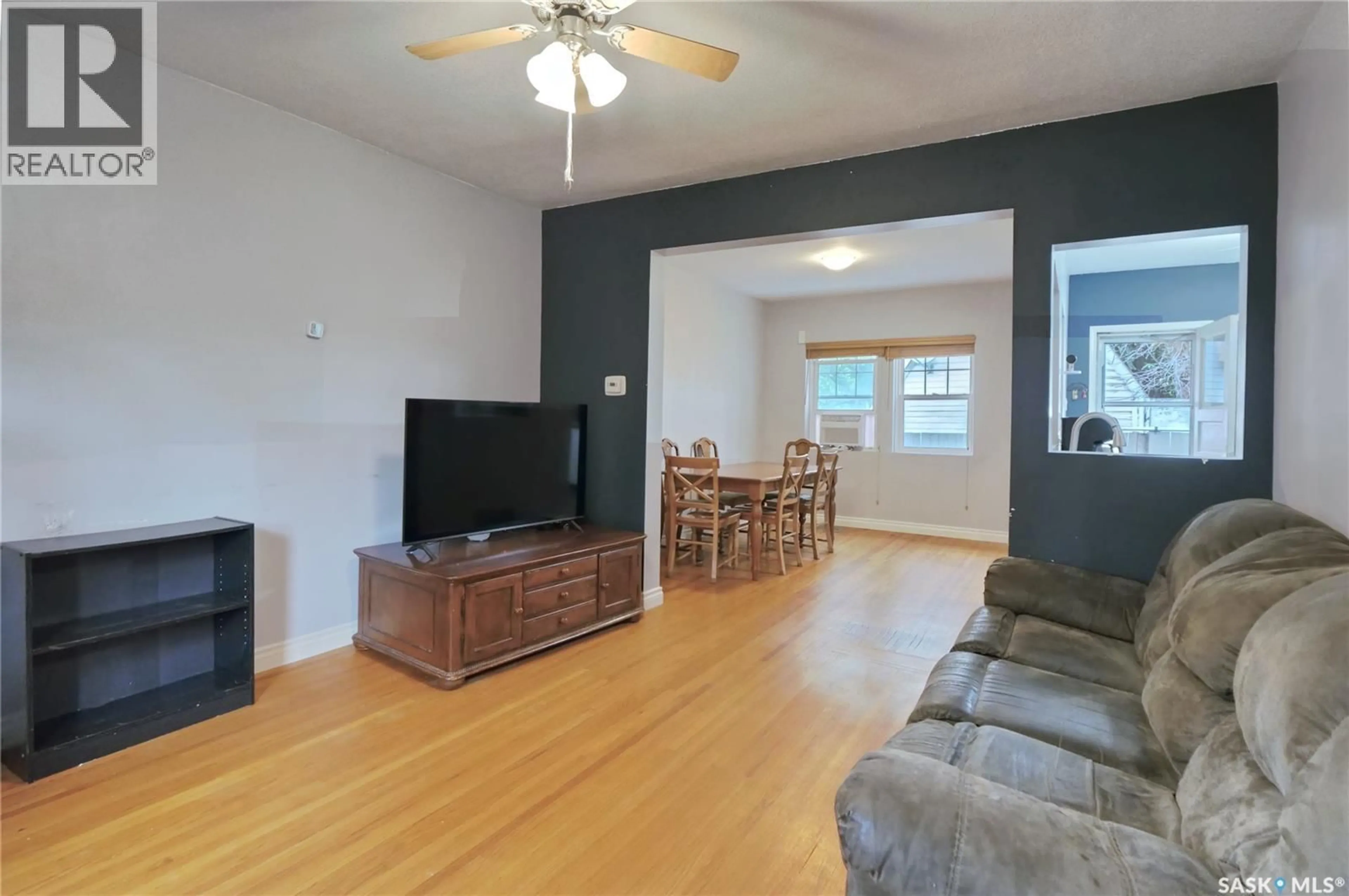 Living room with furniture, wood/laminate floor for 70 CARIBOU STREET, Moose Jaw Saskatchewan S6H0R3