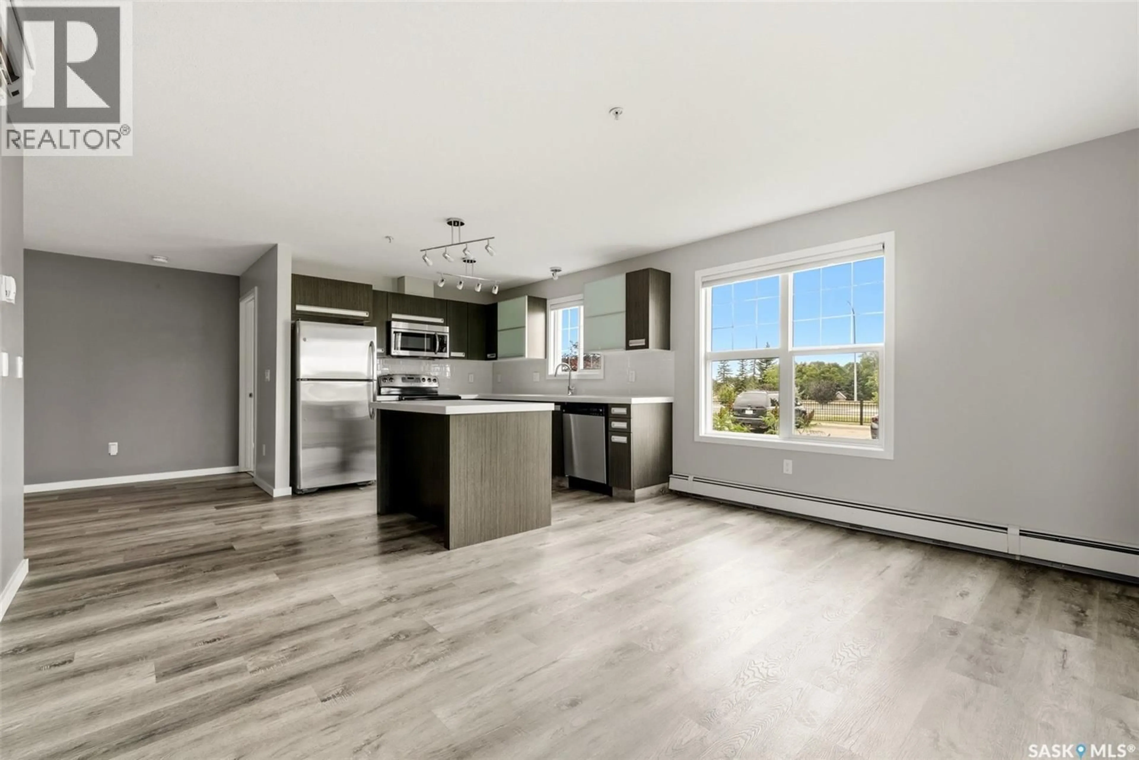 Open concept kitchen, wood/laminate floor for 114 - 1610 DAKOTA DRIVE, Regina Saskatchewan S4Z0A5