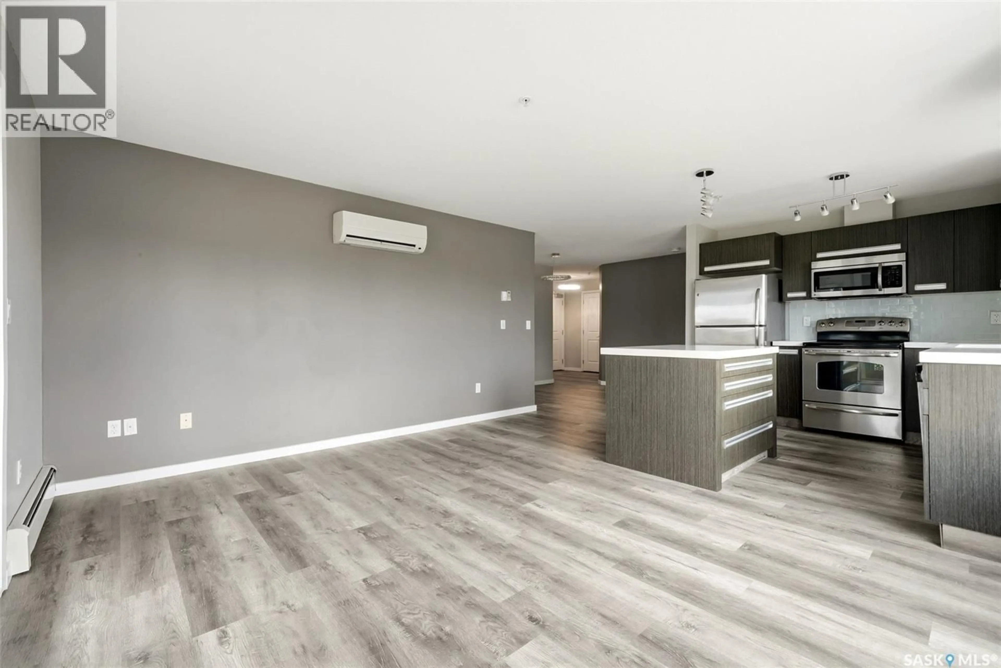 Open concept kitchen, wood/laminate floor for 114 - 1610 DAKOTA DRIVE, Regina Saskatchewan S4Z0A5