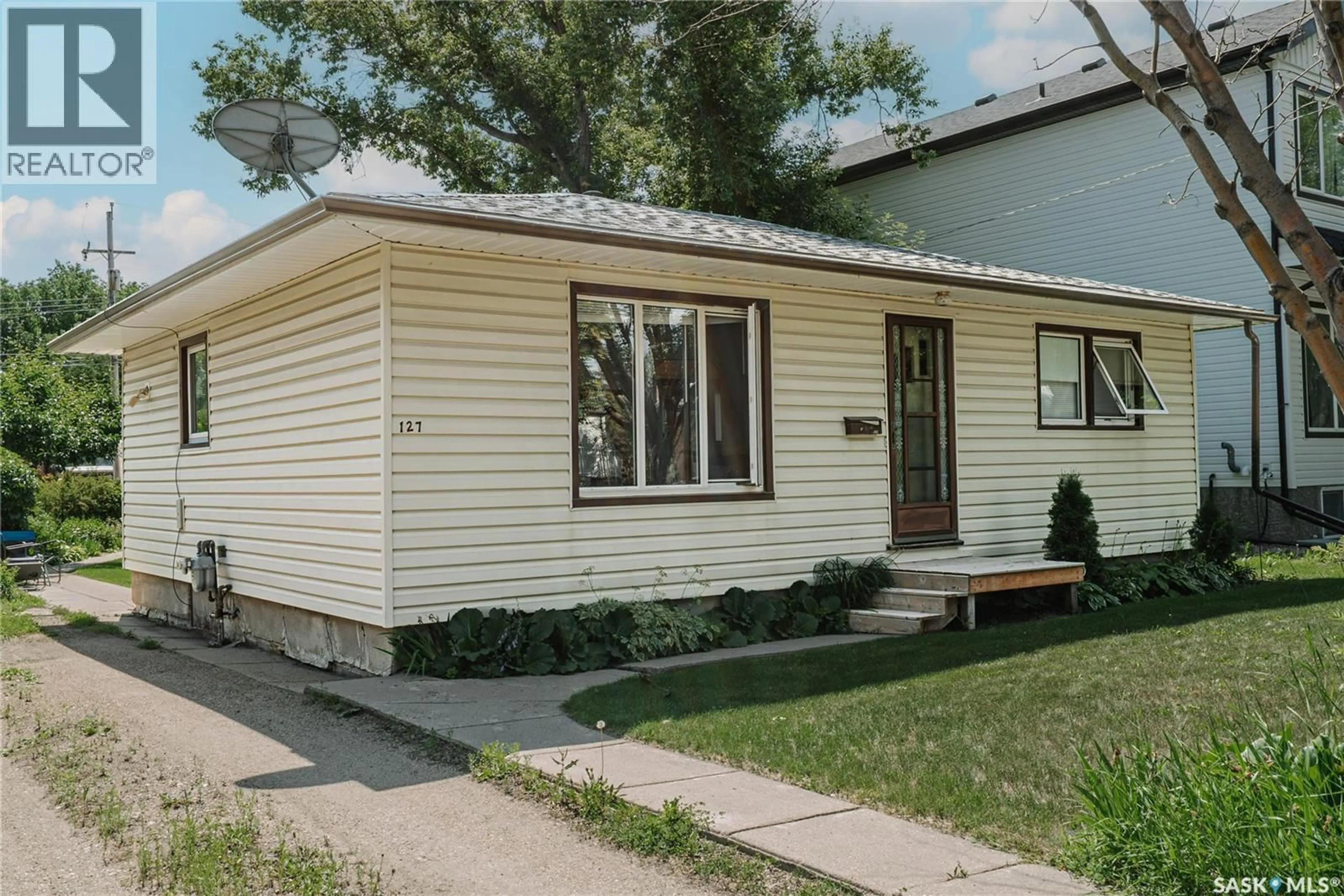 Home with vinyl exterior material, street for 127 107TH STREET, Saskatoon Saskatchewan S7N1P2