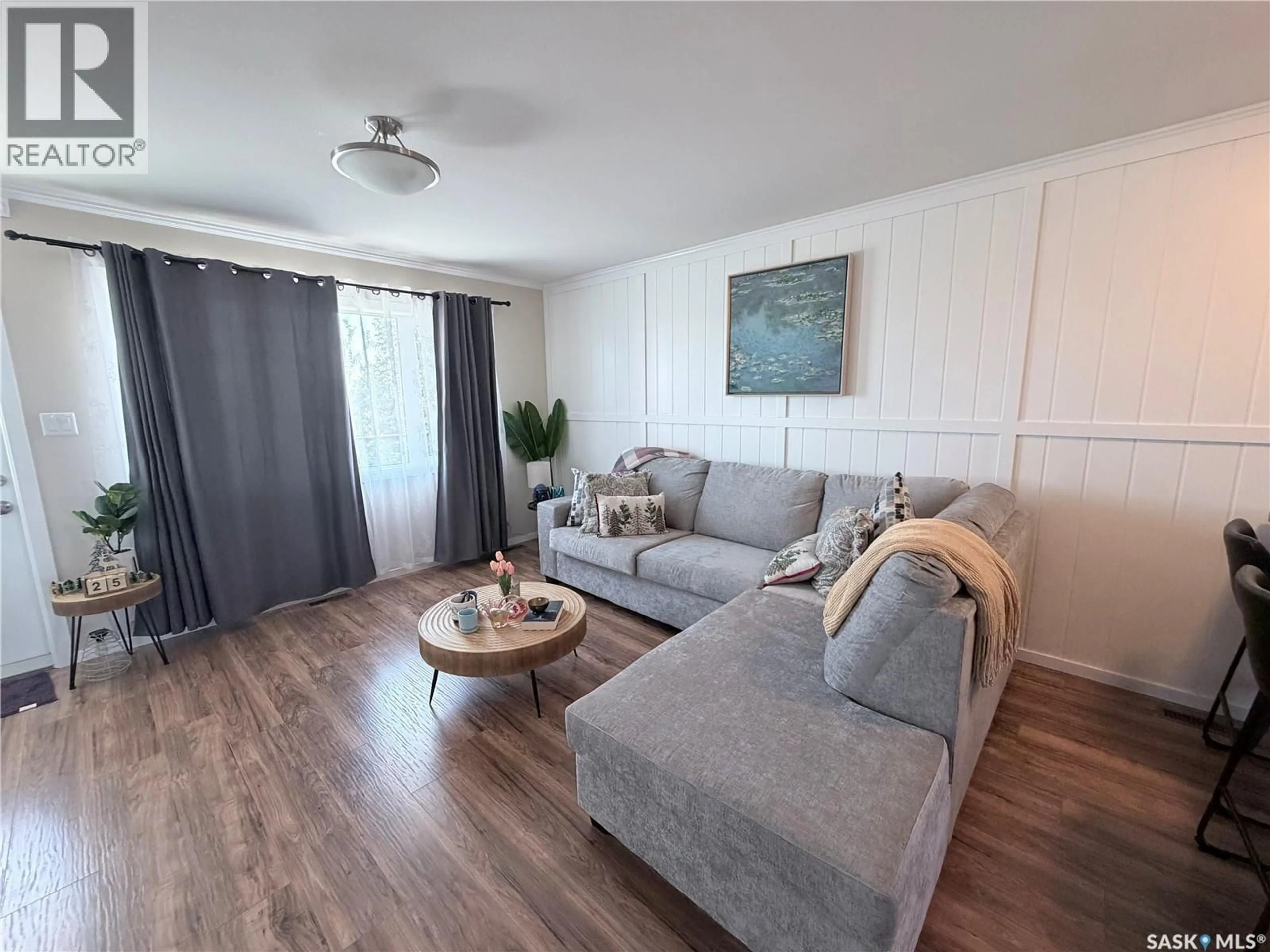 Living room with furniture, wood/laminate floor for 1303 - 708 RICHARDSON ROAD, Saskatoon Saskatchewan S7R0L1