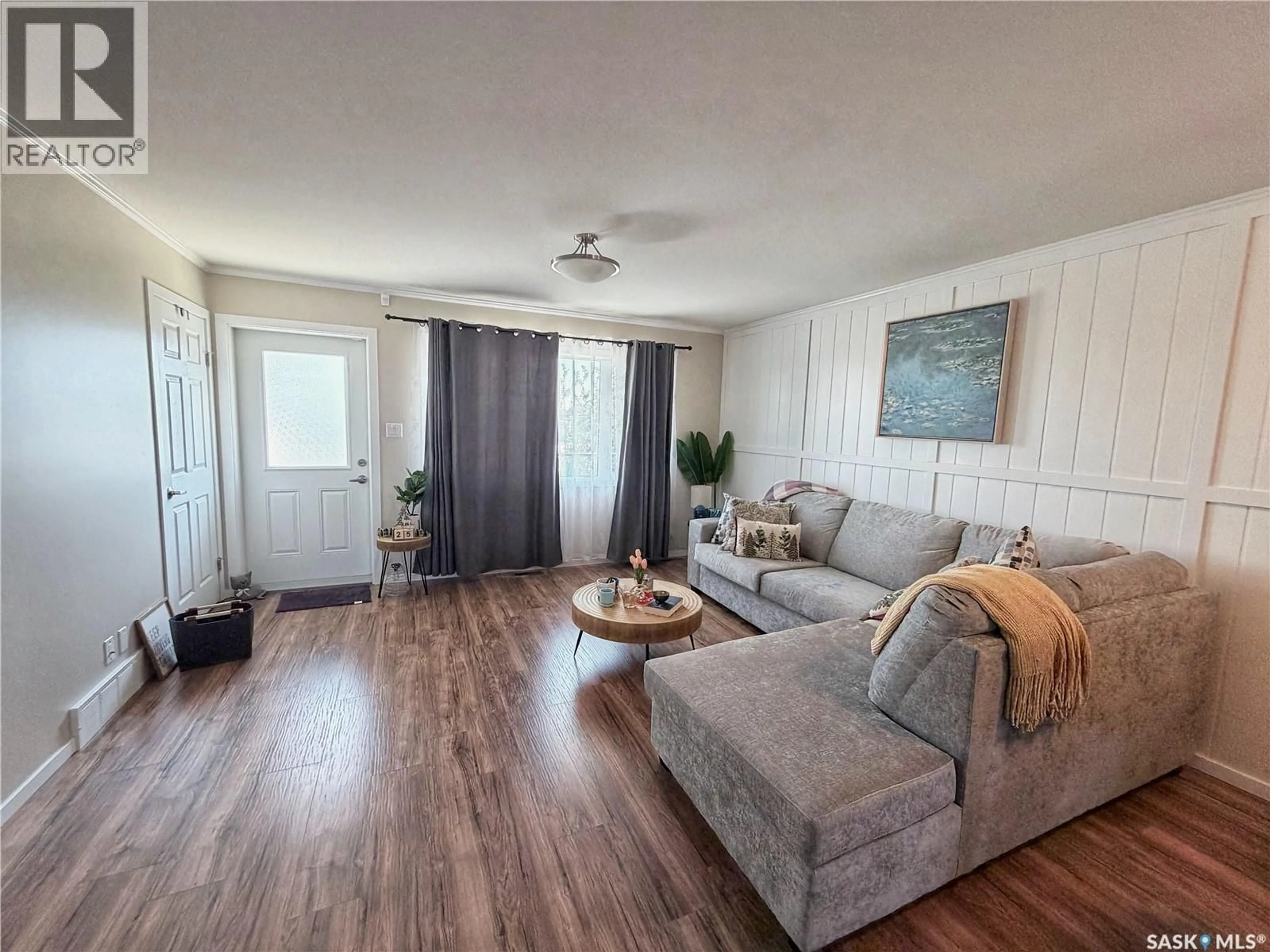 Living room with furniture, wood/laminate floor for 1303 - 708 RICHARDSON ROAD, Saskatoon Saskatchewan S7R0L1