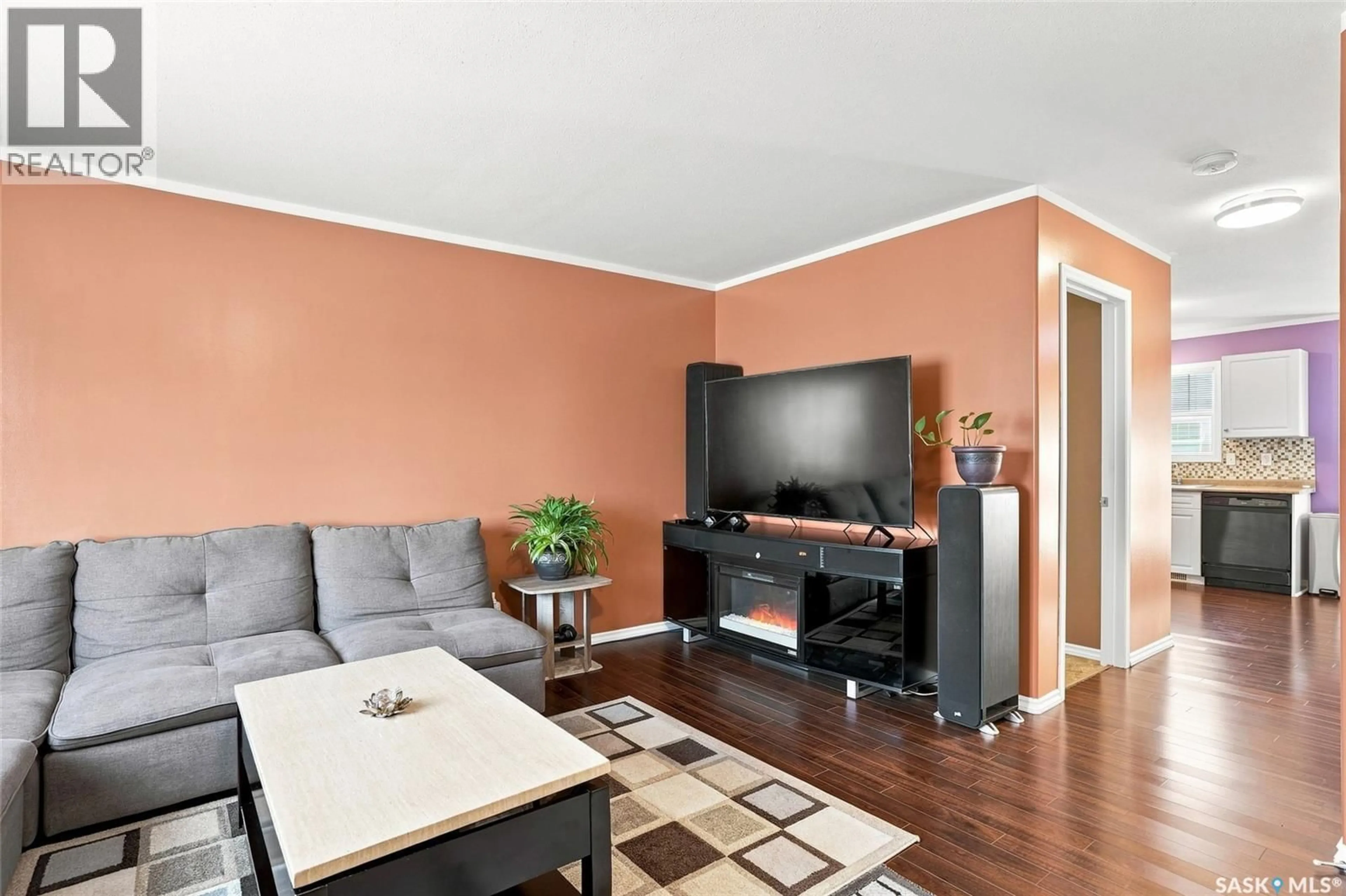 Living room with furniture, wood/laminate floor for 102 - 30 PAWLYCHENKO LANE, Saskatoon Saskatchewan S7V1G9