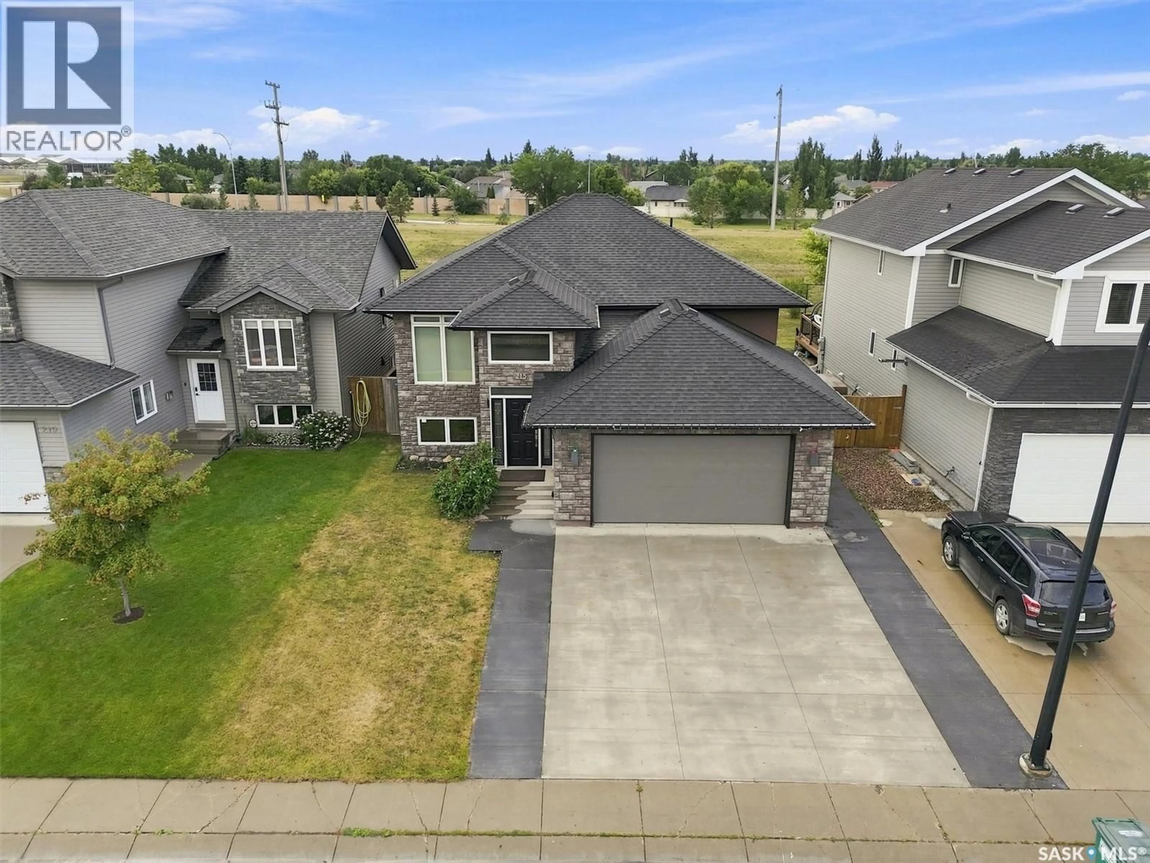 A pic from outside/outdoor area/front of a property/back of a property/a pic from drone, street for 215 PADGET CRESCENT, Saskatoon Saskatchewan S7W0H4