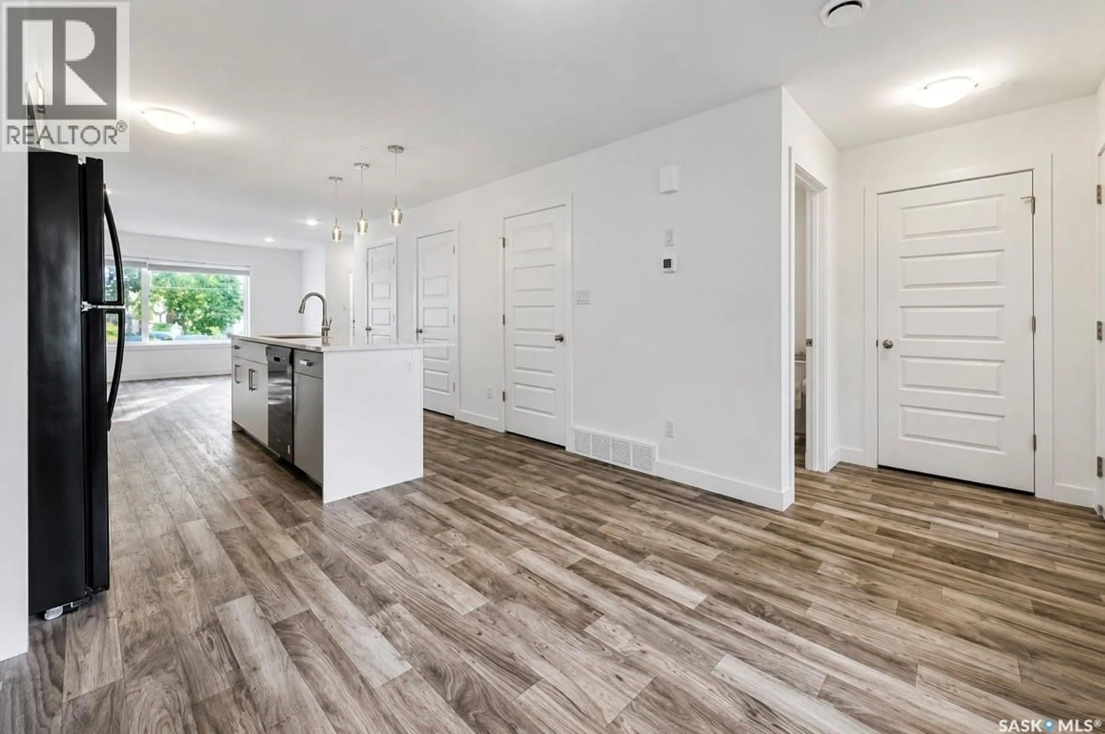 Open concept kitchen, wood/laminate floor for 2464 FRANCIS STREET, Regina Saskatchewan S4N2P9