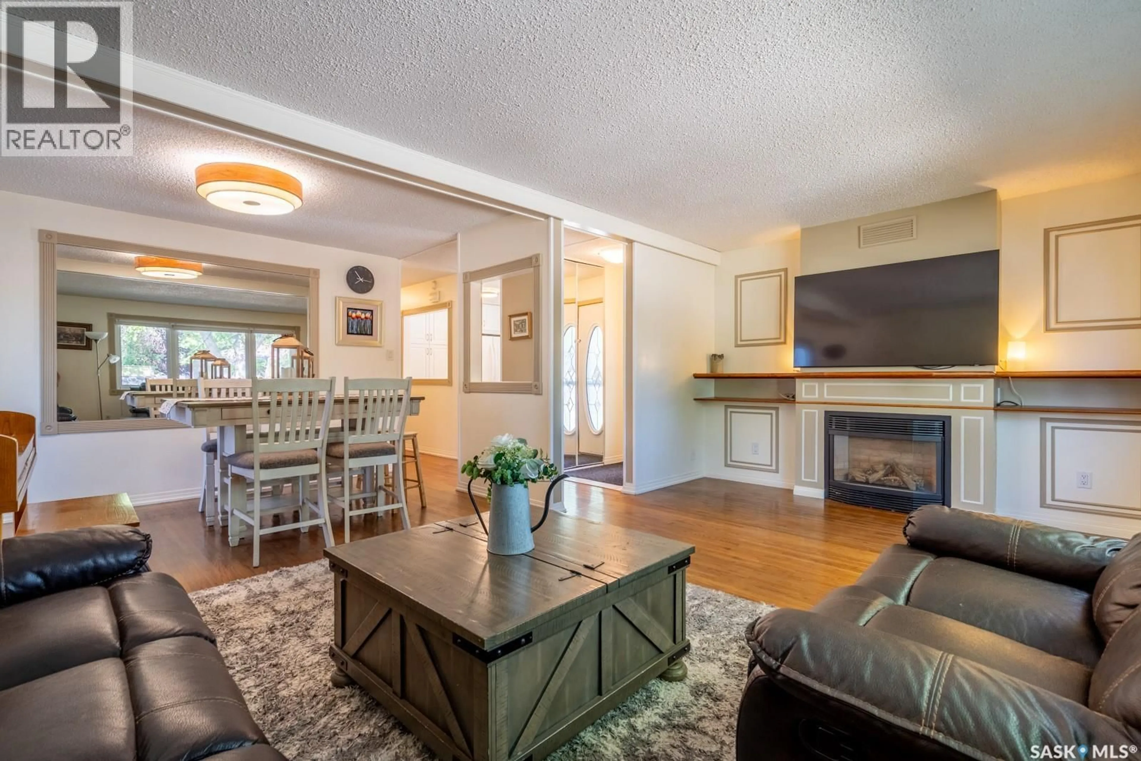 Living room with furniture, wood/laminate floor for 24 MAYFAIR CRESCENT, Regina Saskatchewan S4S4H5