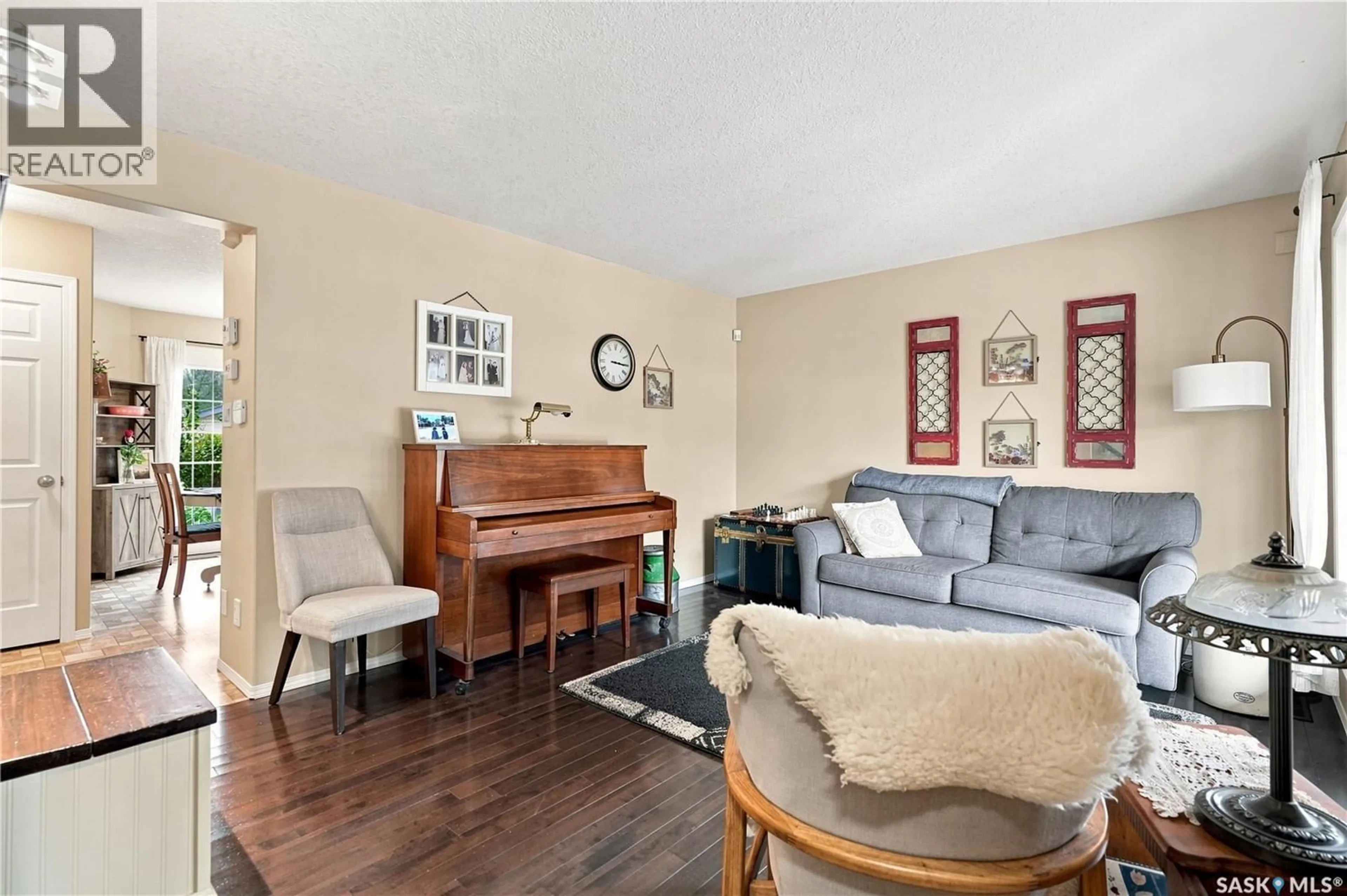 Living room with furniture, wood/laminate floor for 1030 ORCHID WAY, Regina Saskatchewan S4X4R4