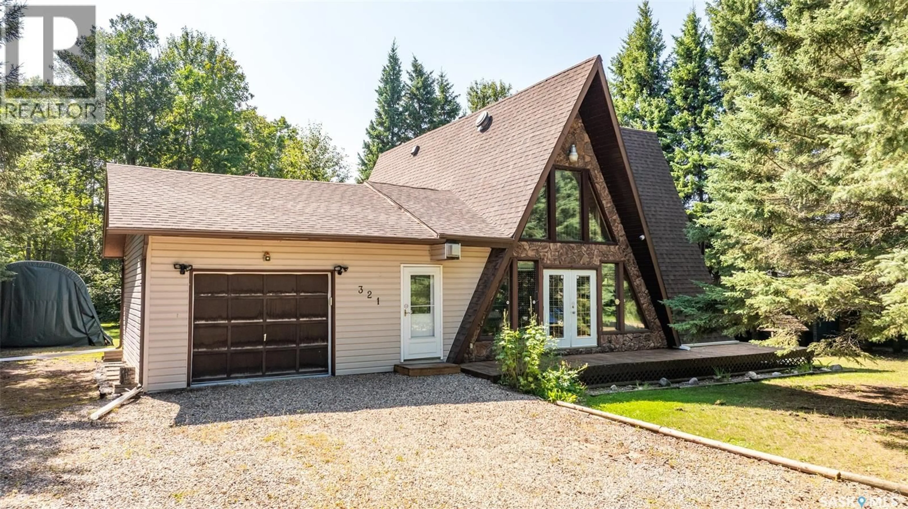 Home with vinyl exterior material, street for 321 JACOBSON DRIVE, Christopher Lake Saskatchewan S0J0N0