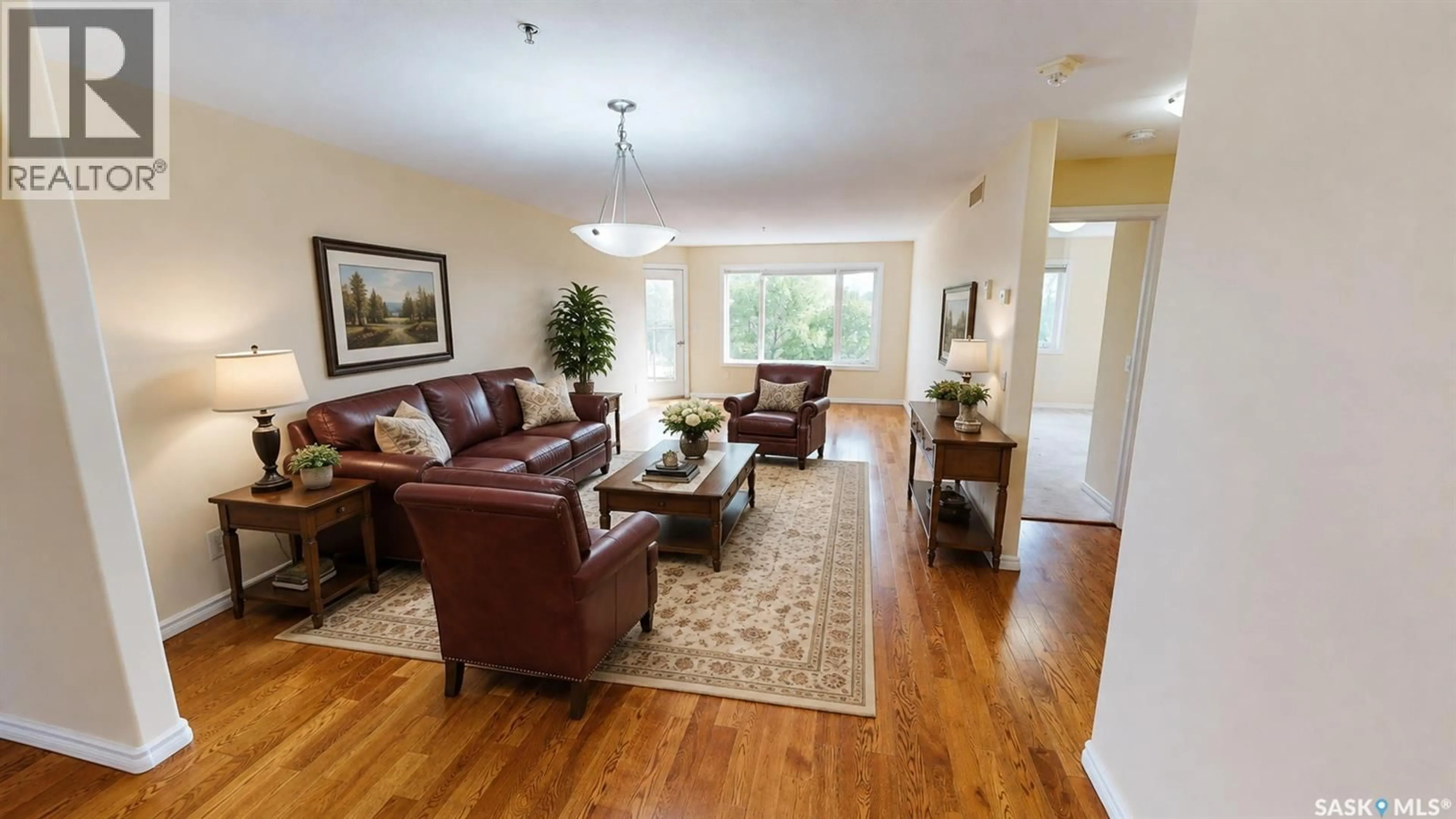 Living room with furniture, wood/laminate floor for 305 - 3101 RENFREW CRESCENT, Regina Saskatchewan S4V3B6