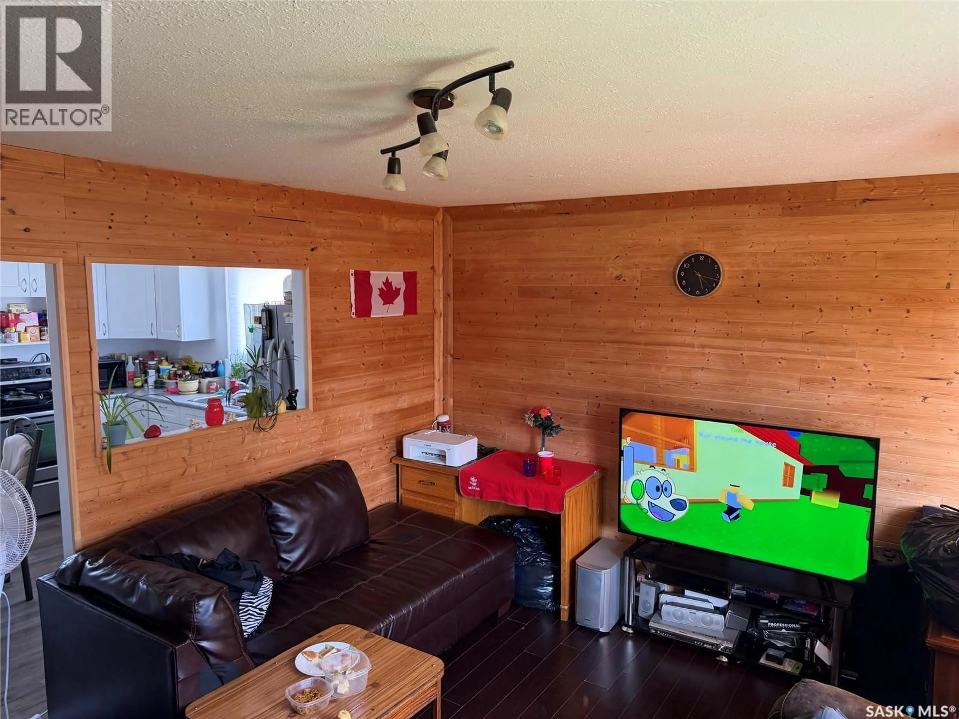 Living room with furniture, wood/laminate floor for 409 1ST AVENUE, Spiritwood Saskatchewan S0J2M0